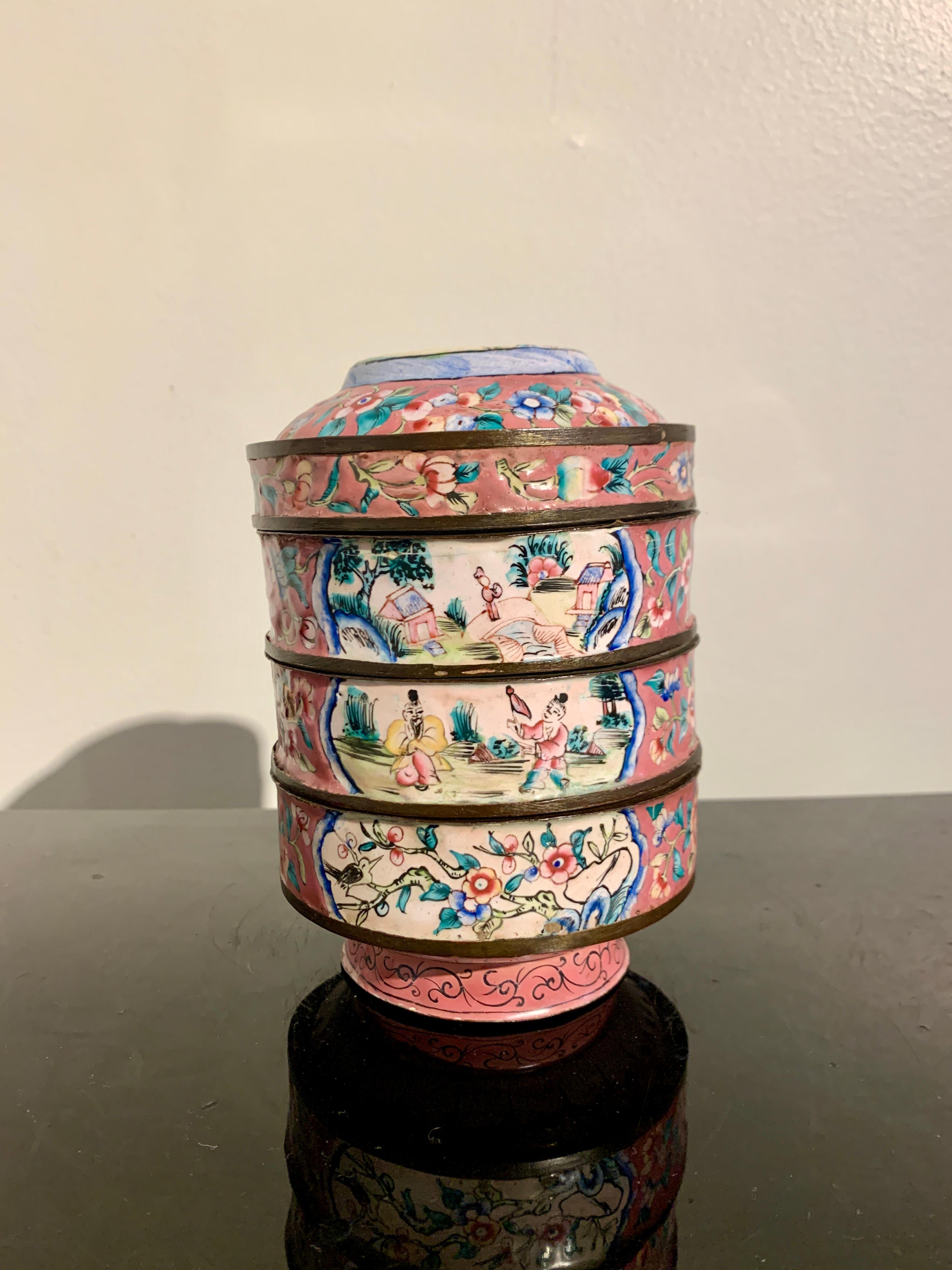 An absolutely lovely Chinese export pink Canton enamel round stacking box and cover, late Qing Dynasty, circa 1900, China.

The circular stacking box consists of a bowl form base, two round stacking round trays, and a cover that can be inverted to