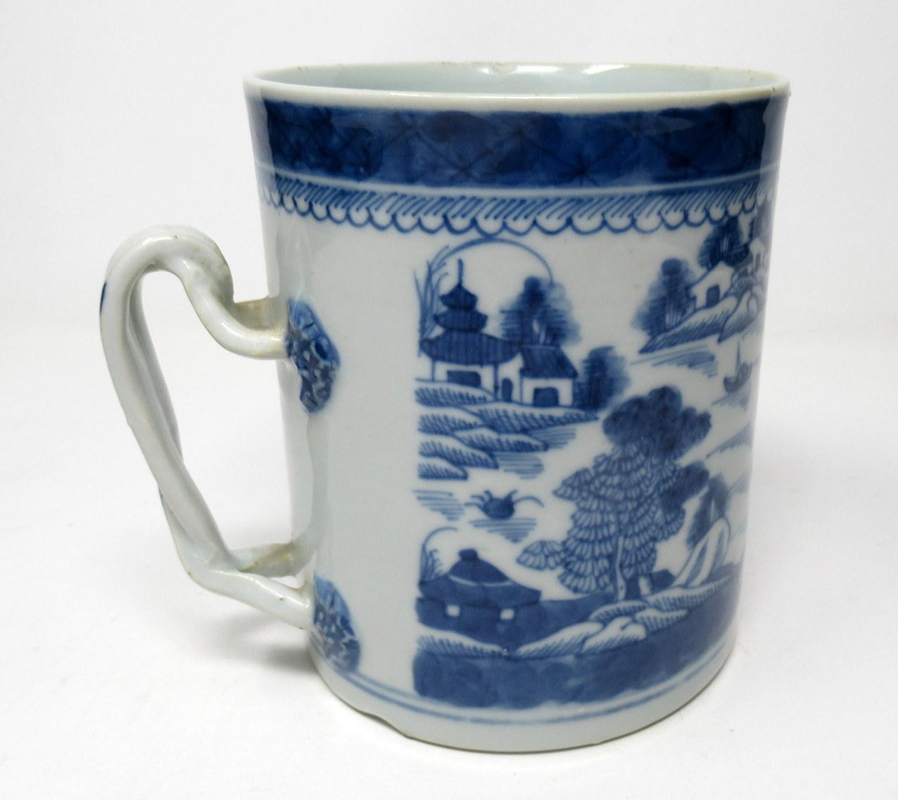 A very fine Chinese export hand decorated blue and white porcelain tankard of unusually large proportions, superbly decorated depicting a continuous view of a Chinese village with a river and landscape scene. Applied decorative moulded cross-over