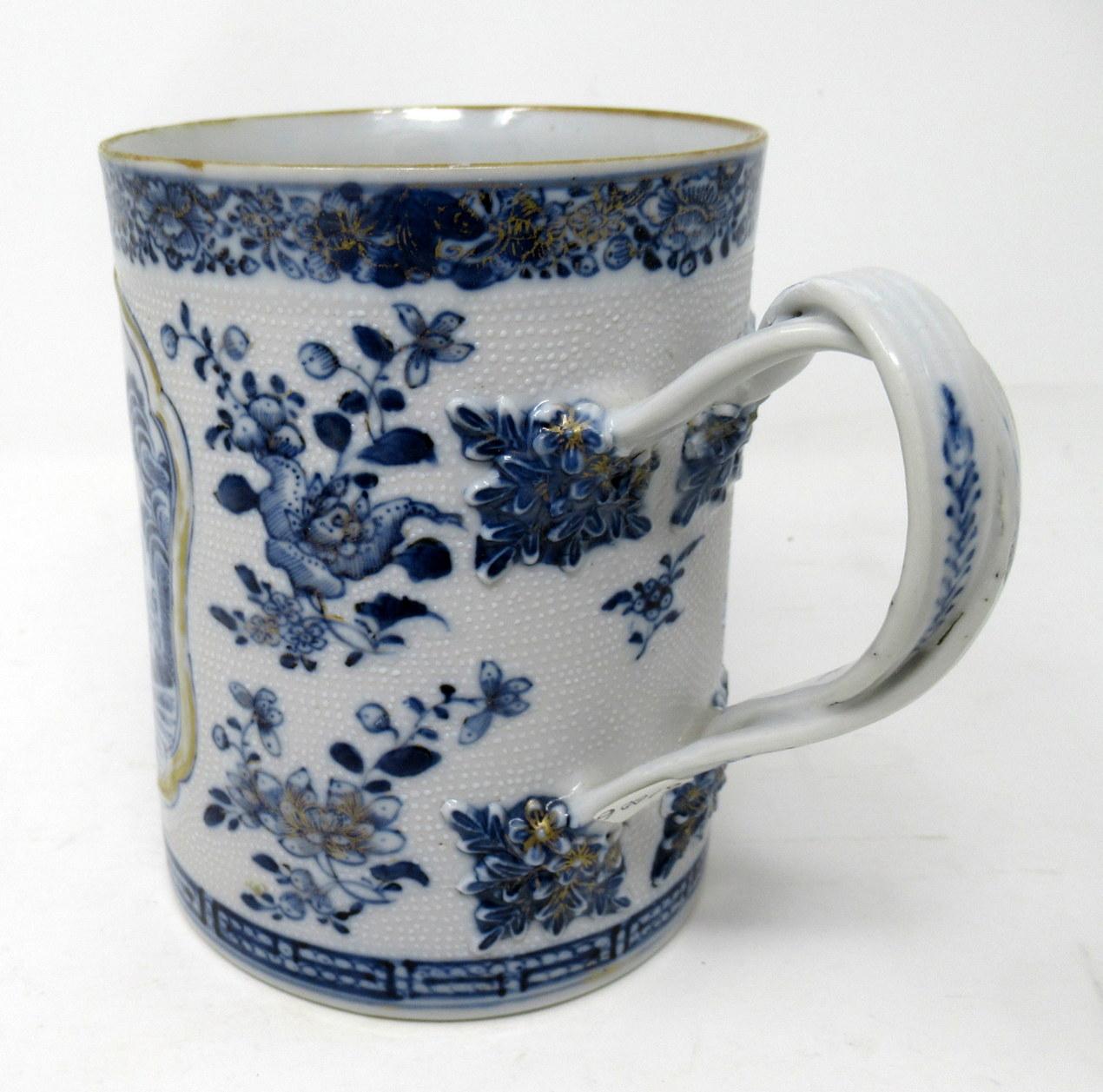 A very fine Chinese export hand decorated blue and white porcelain tankard of unusually large proportions and exceptional quality, superbly decorated depicting a central framed reserve of a view of a Chinese Village with a river and landscape scene,