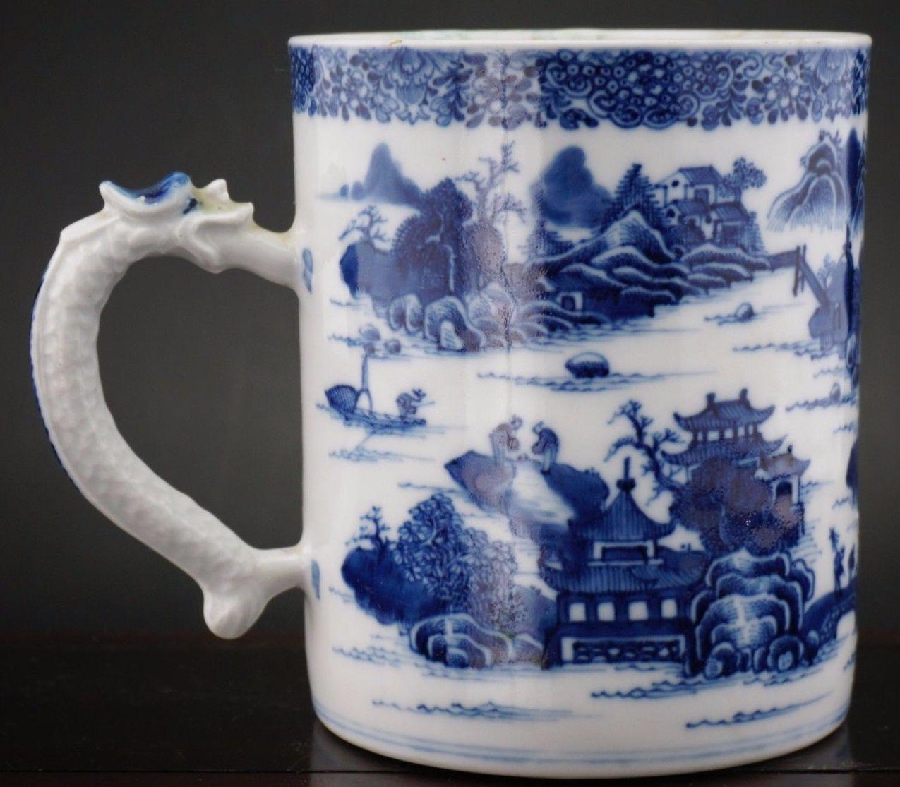 A very fine Chinese export hand decorated blue and white porcelain tankard of unusually large proportions, superbly decorated depicting a continuous view of a Chinese village with a river and landscape scene. Applied decorative moulded dragon