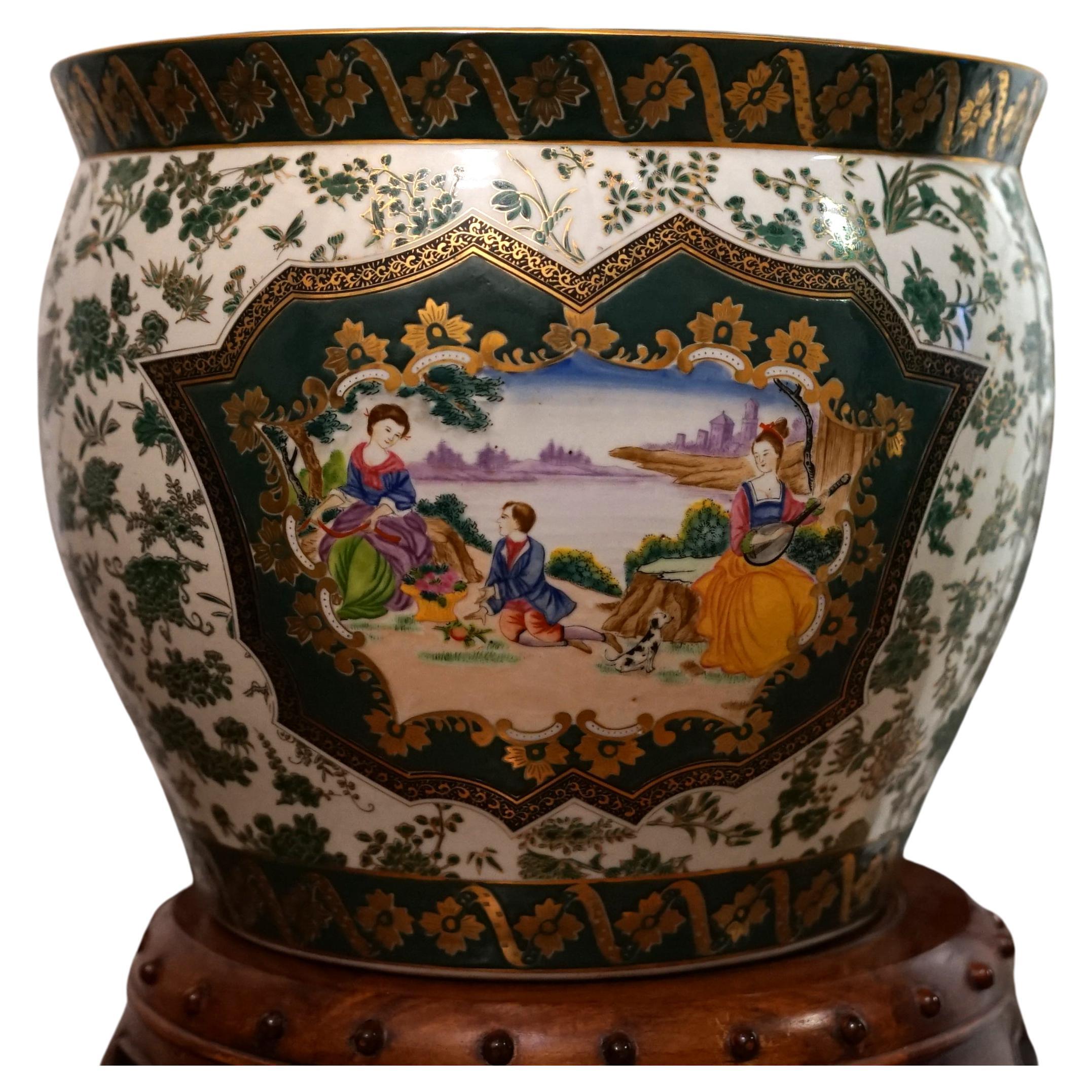 The gilt design and gold trim details as well as the deep green ground make this set of Canton Chinese jardinieres unique. This lovely pair of estate sale jardinieres has scenes on both sides of the pots. The pieces stand out overall with their