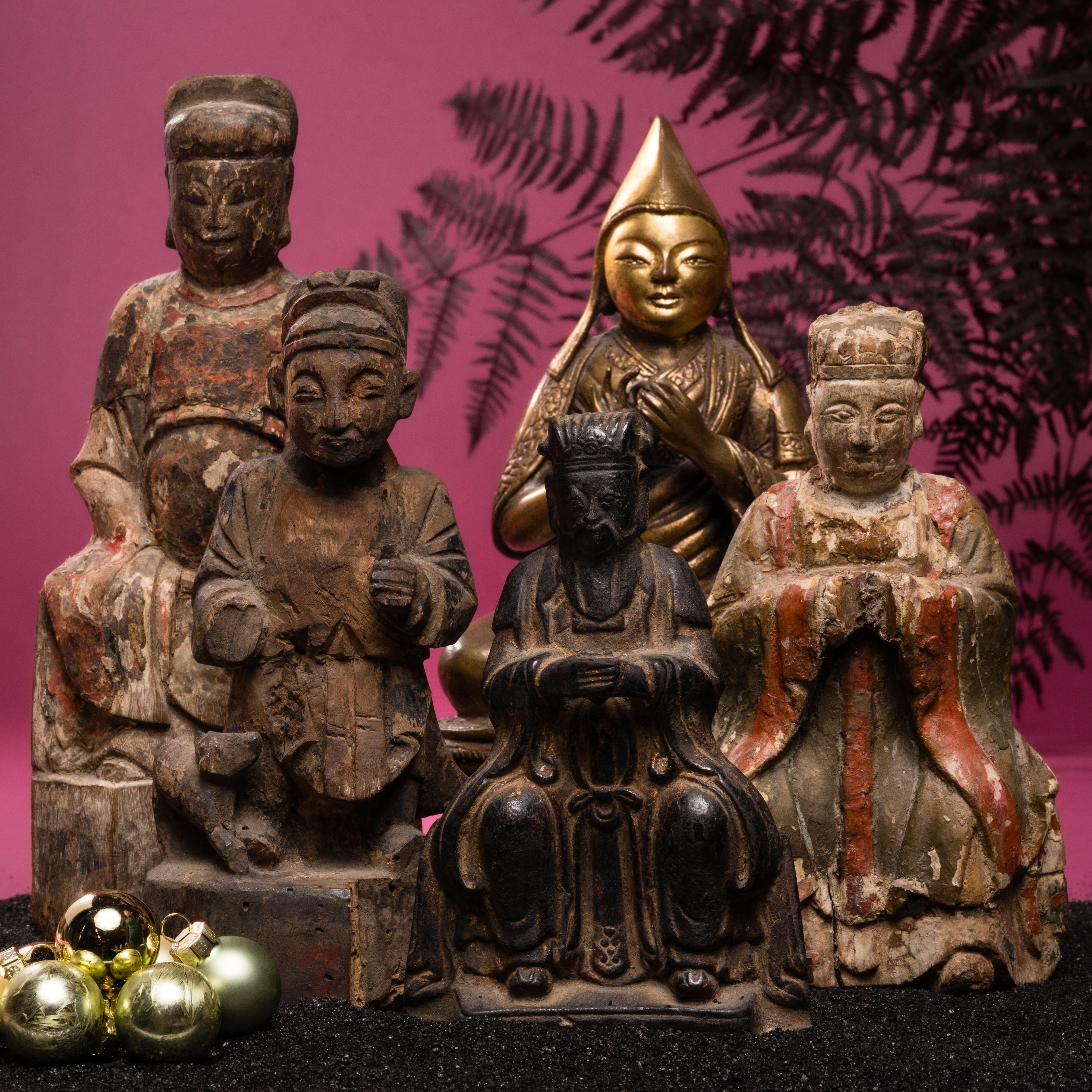 Ancestor worship was an integral part of traditional Chinese home life. This carved figure bears the likeness of one of its original owner's important forebears. A cat curves around the elder's right leg, a symbolic pairing associated with age,