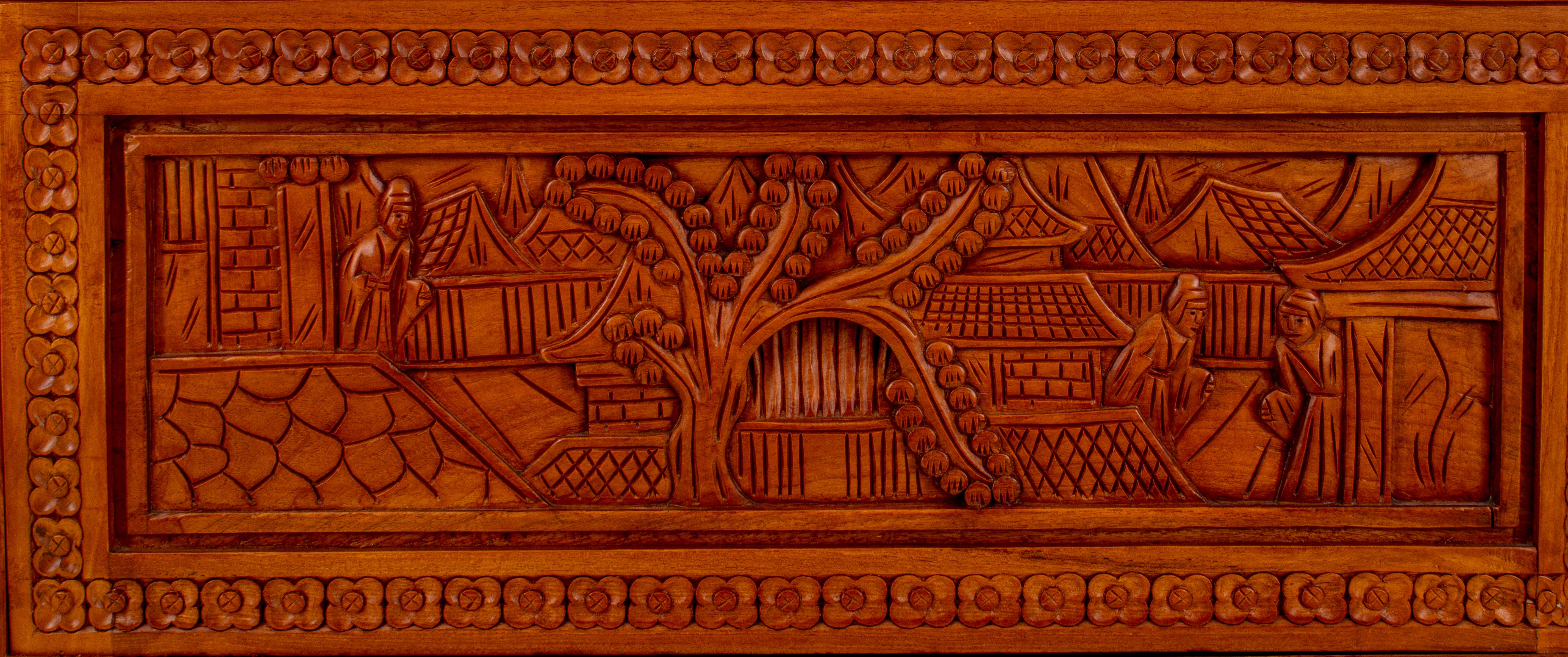 Chinese carved aromatic wood cocktail cabinet, the rounded rectangular top and drop front opening to reveal a fitted bar above a two-door cabinet, with concealed curving doors to corners. The whole carved in relief with Chinese urban
