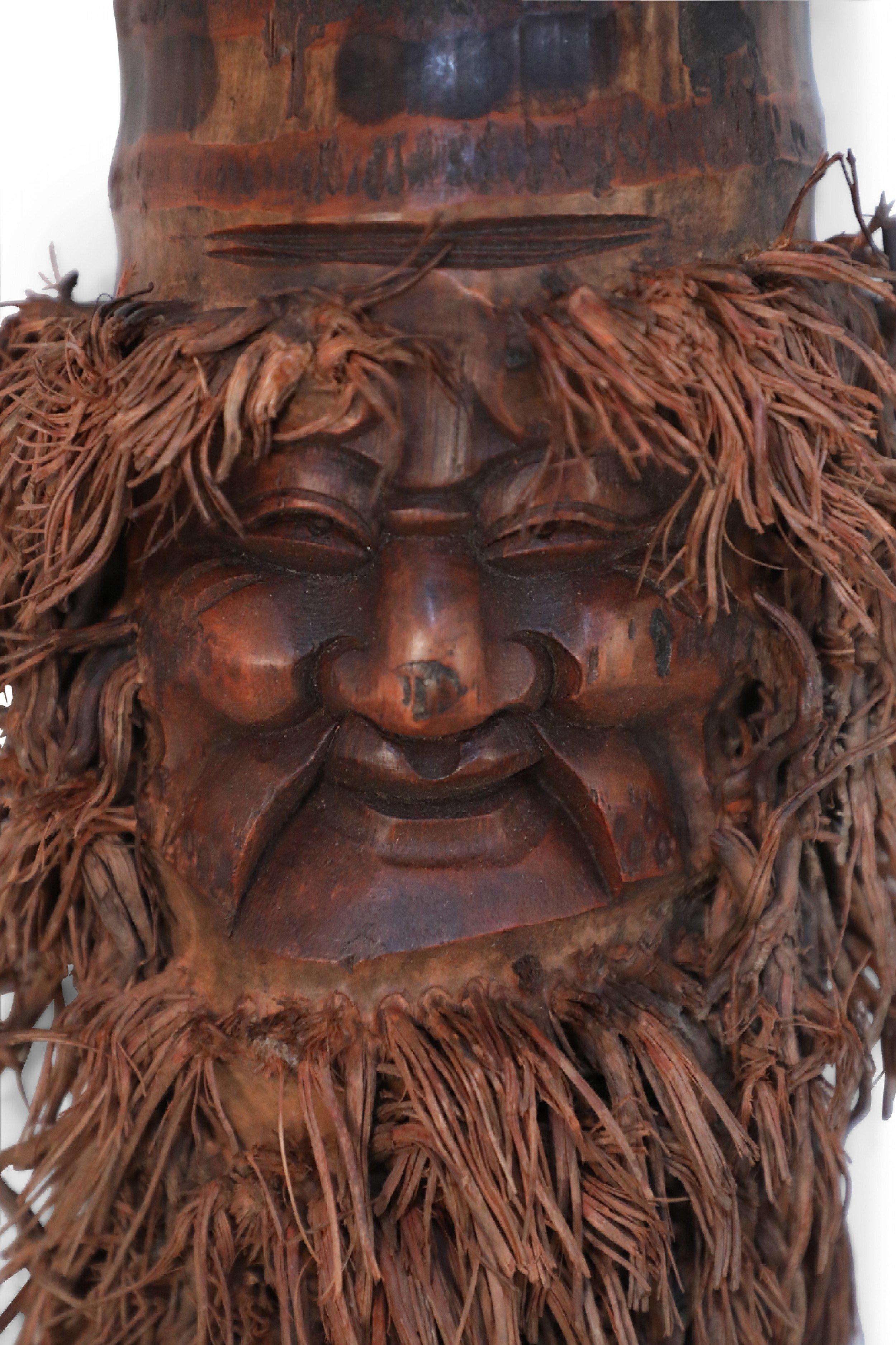Chinese wall plaque made from a bamboo root carved in the shape of a smiling face with a bamboo root fiber beard. (Companion pieces: NWL2543A-F).    
   