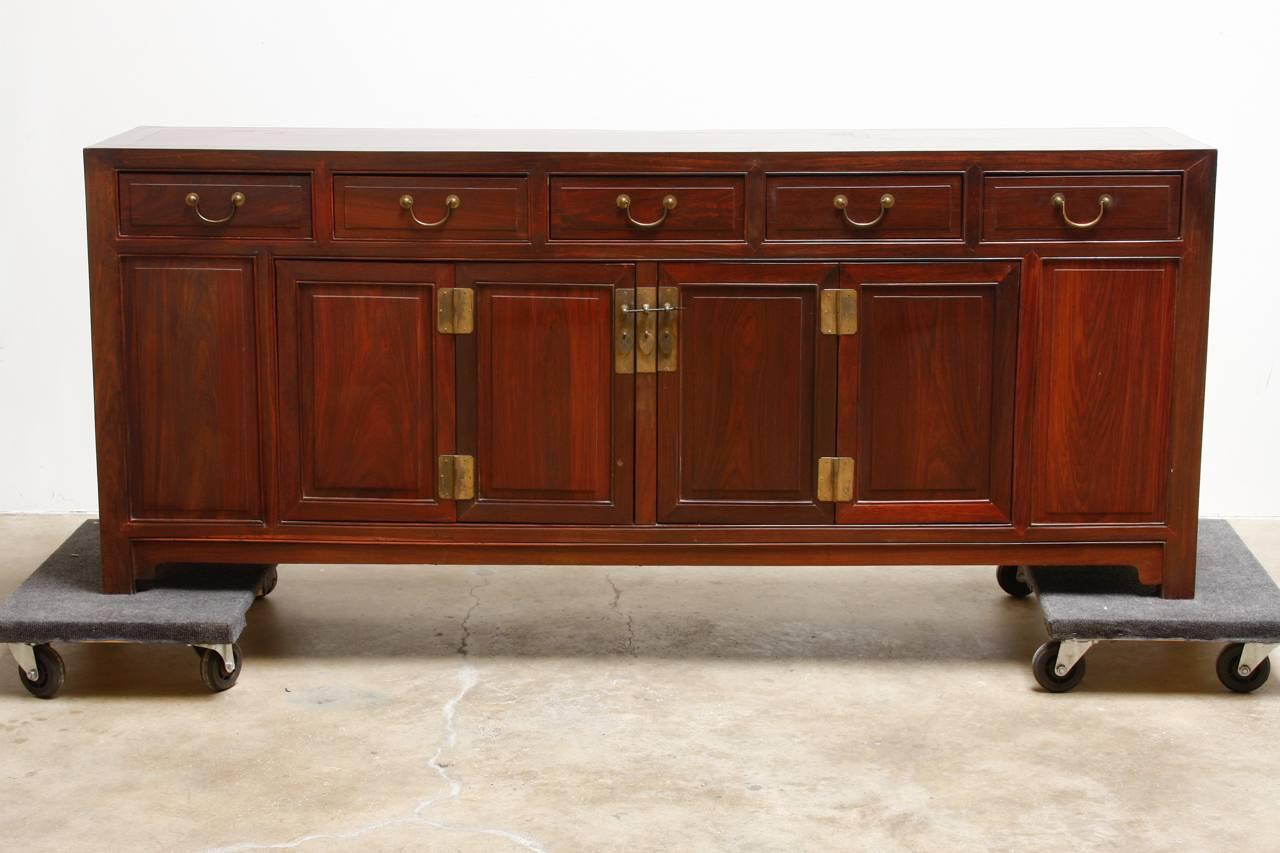 Large Chinese carved rosewood buffet sideboard cabinet constructed from solid rosewood. Very substantial weighing nearly 300 pounds and featuring an open 
