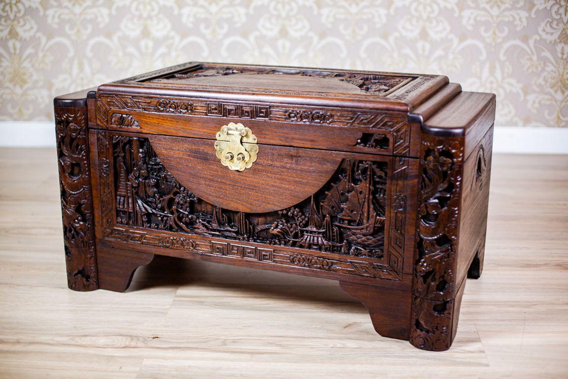 We present you an oak chest from the 1930s.
The lid and the front of the chest are ornate with beautiful carving that depicts Chinese genre scenes.

Presented chest is after renovation and finished in wax.