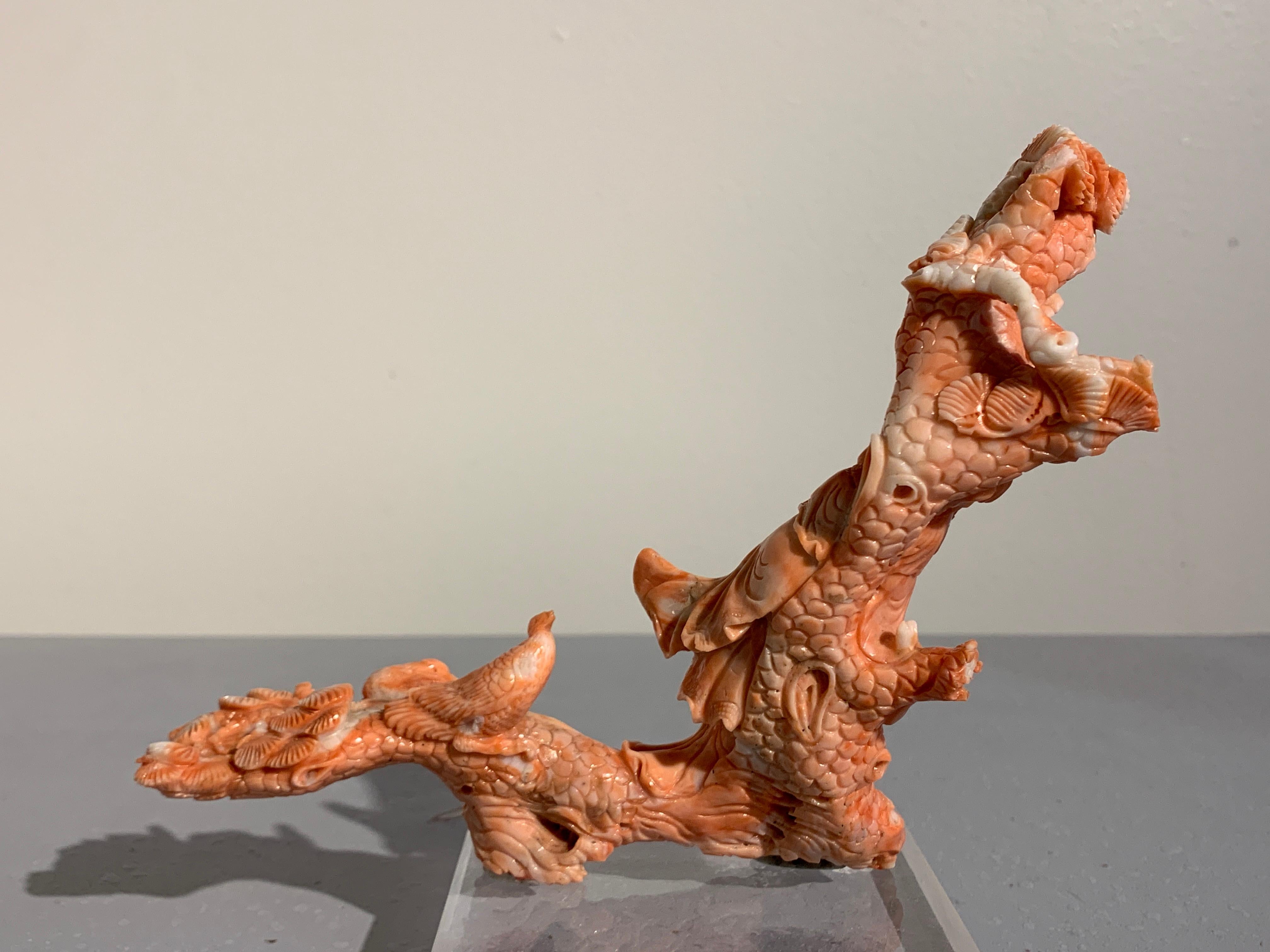 A wonderfully Chinese carved coral branch in the form of Shou Lao, also called Shouxing, the Chinese god of longevity, Republic period, early 20th century.

Intricately carved from a single large branch of pinkish orange coral, the jovial Shou Lao