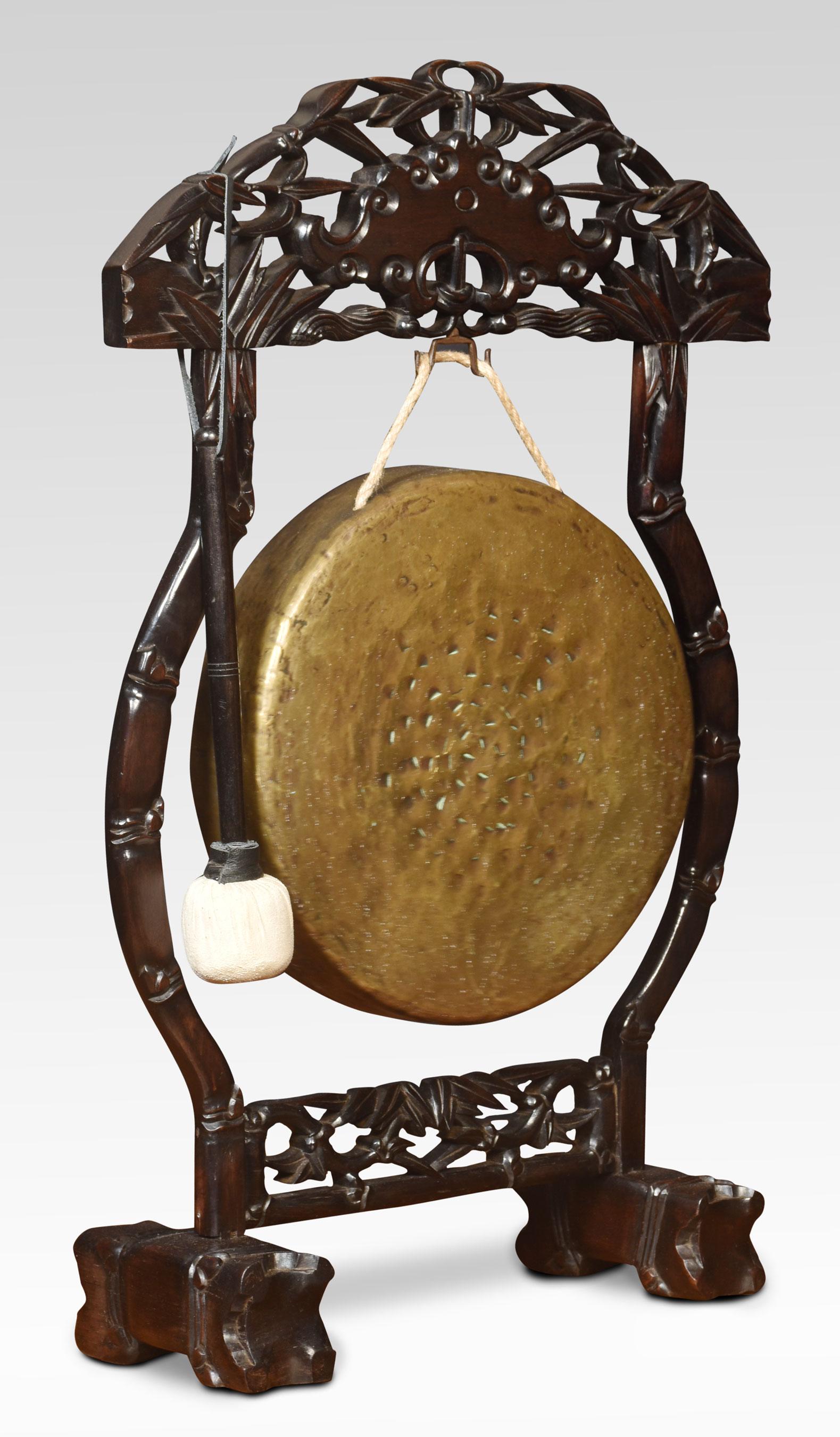 Chinese dinner gong, the profusely carved frame with pierced decoration, supporting the original brass gong and beater. All raised up on stylised block feet.
Dimensions
Height 31 Inches
Length 19.5 Inches
Width 7.5 Inches