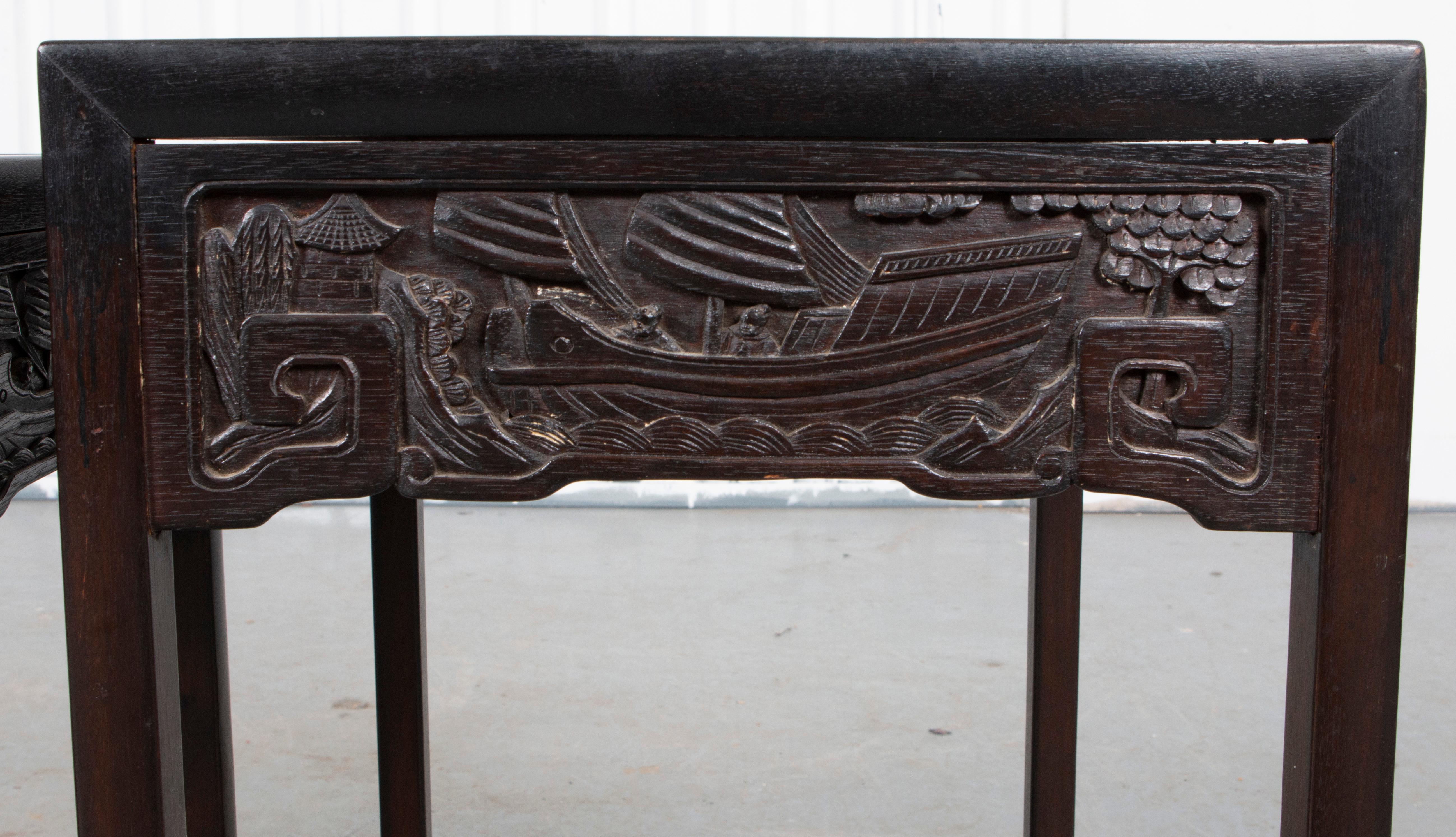 Chinese ebonized nesting tables with carved friezes. Largest 23.75” H x 13.75” W x 15.5” D.