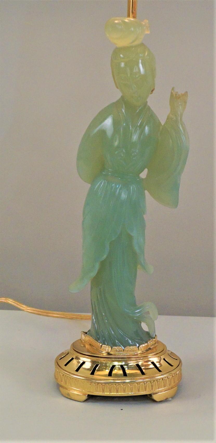 Chinese 1930s carved jade sitting on doré bronze base table lamp.
Chinese jade import to Europe fitted with bronze base in France.
This lamp is fitted with silk lampshade.