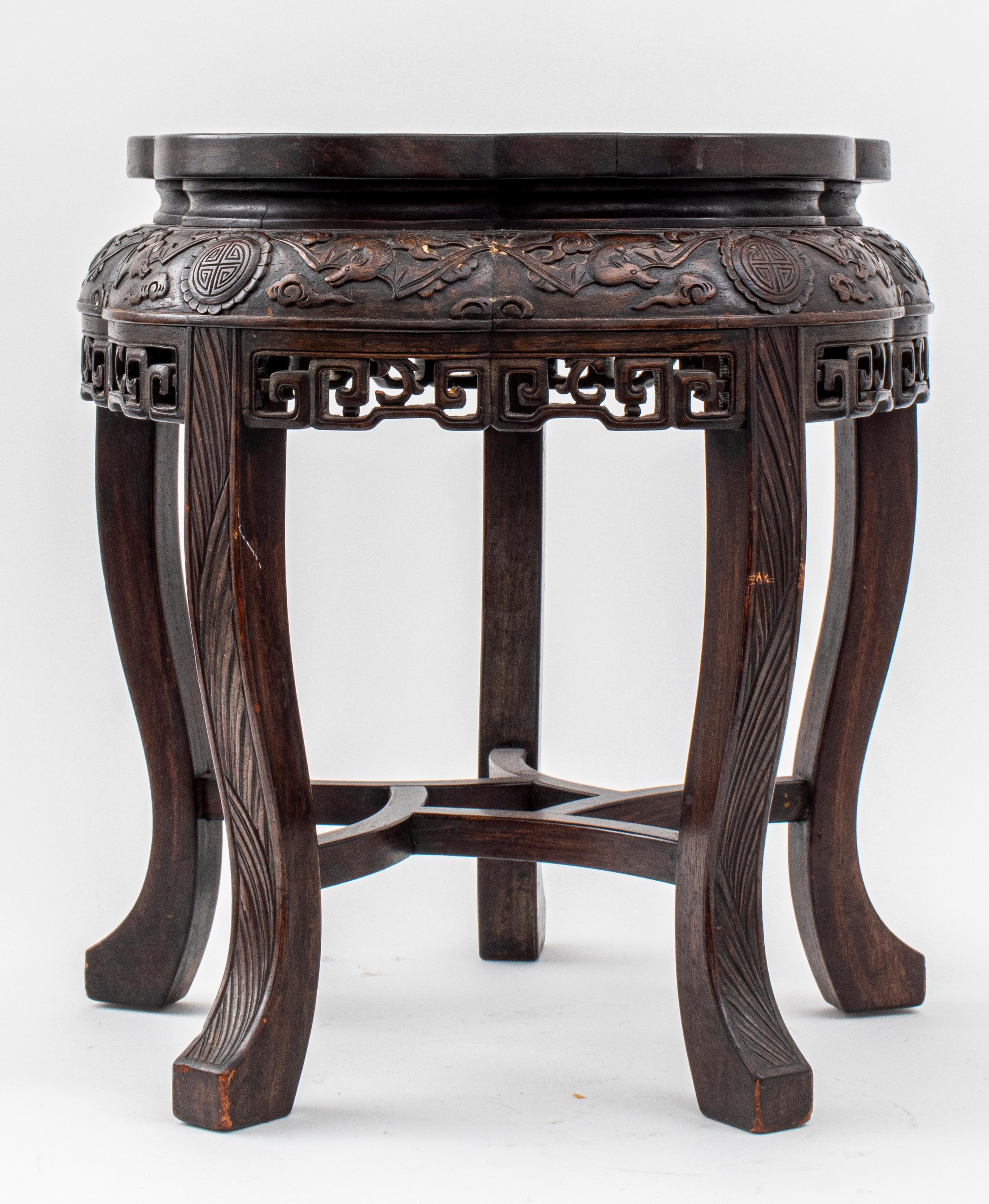 Chinese wood table carved with bats amongst stylized clouds above a pierced geometric apron, upon five cabriole legs. 

Dealer: S138XX