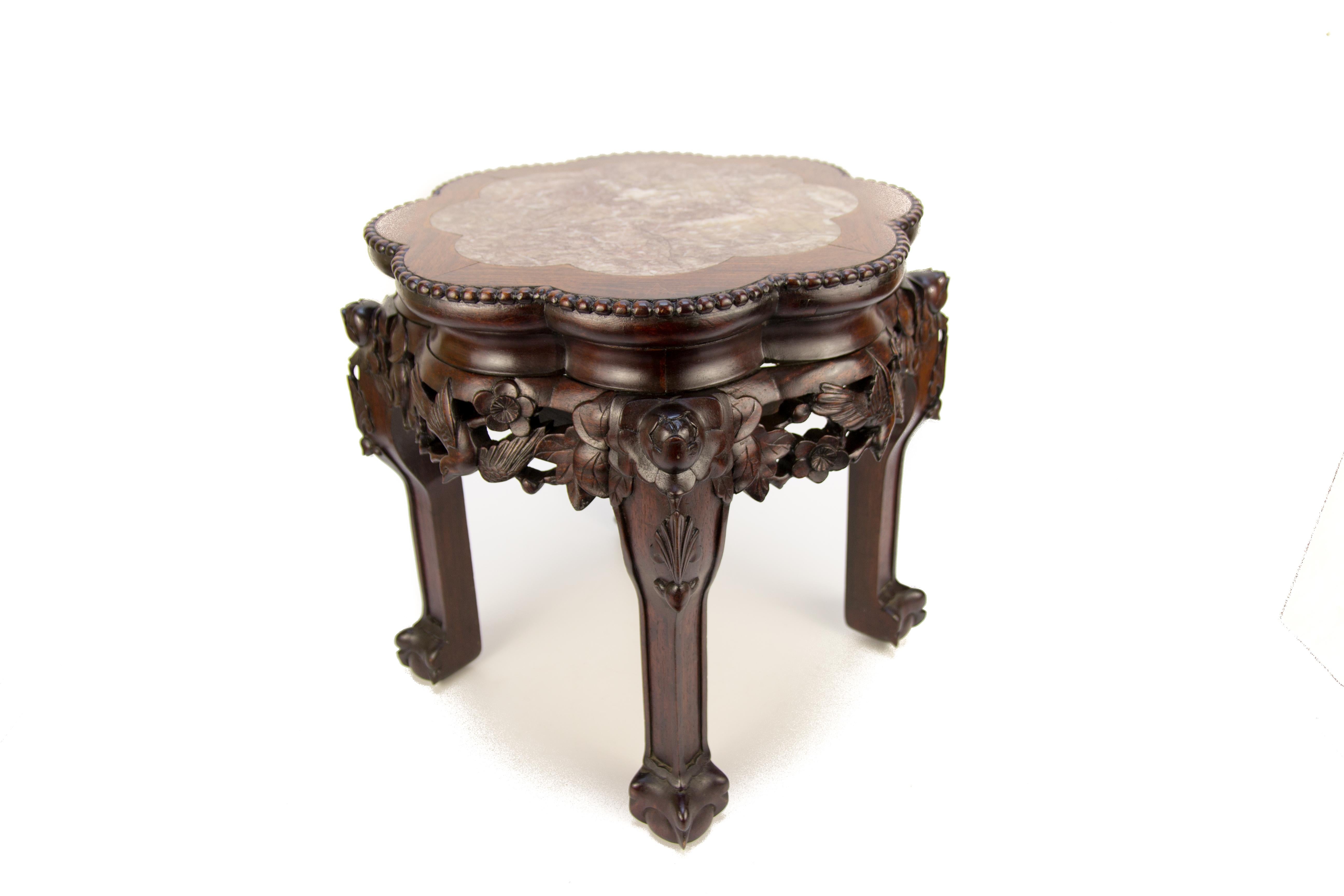 Chinese carved hardwood pot stand or small table with shaped marble inlaid top. Beautiful flower and bird carvings.
Measures: Diameter 45 cm / 17.7 in; height 38 cm / 15 in.