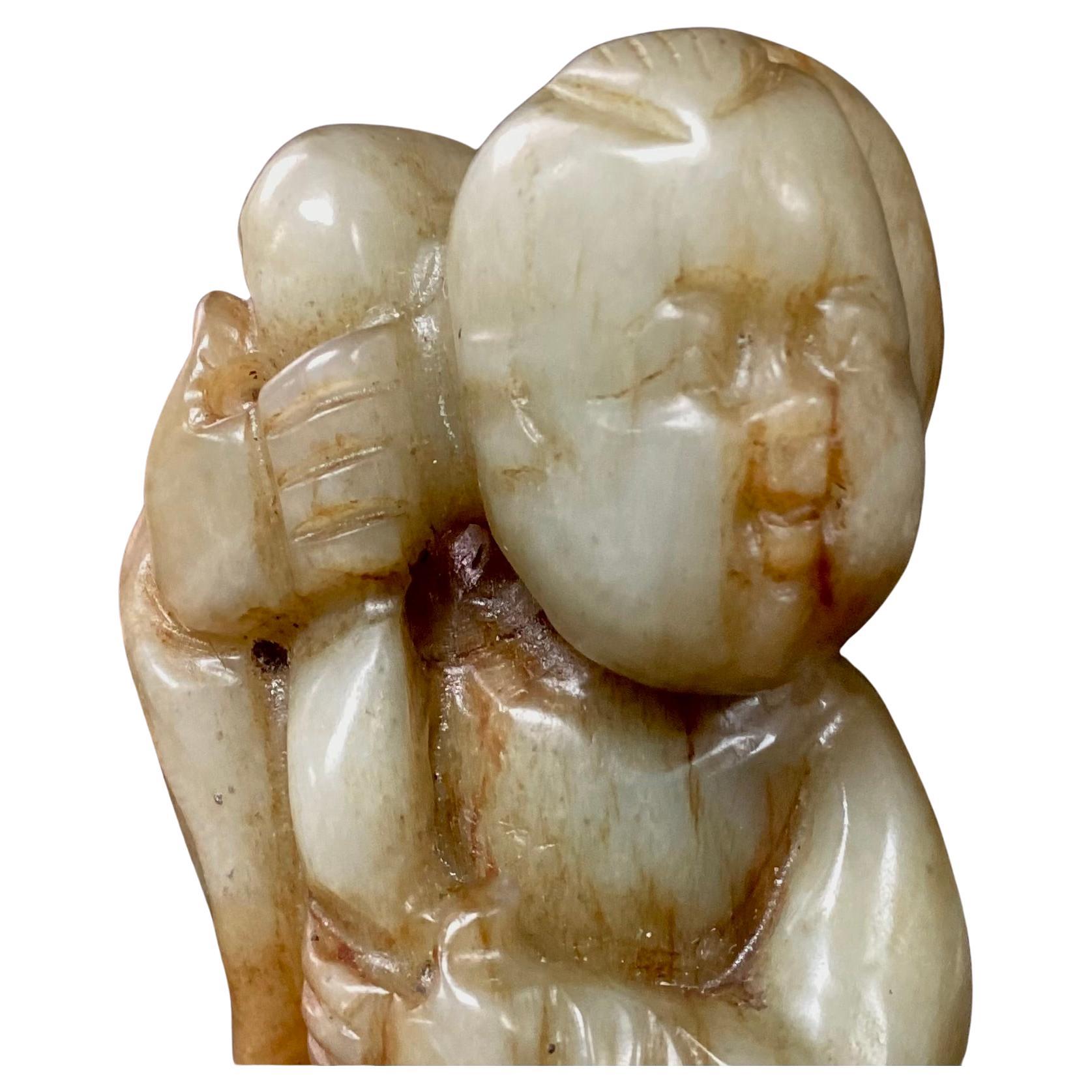 19th Century Chinese Hetian Jade intricate carving of a boy in sitting position. Jade is green and rust in color. A wonderful addition to any jade collection.