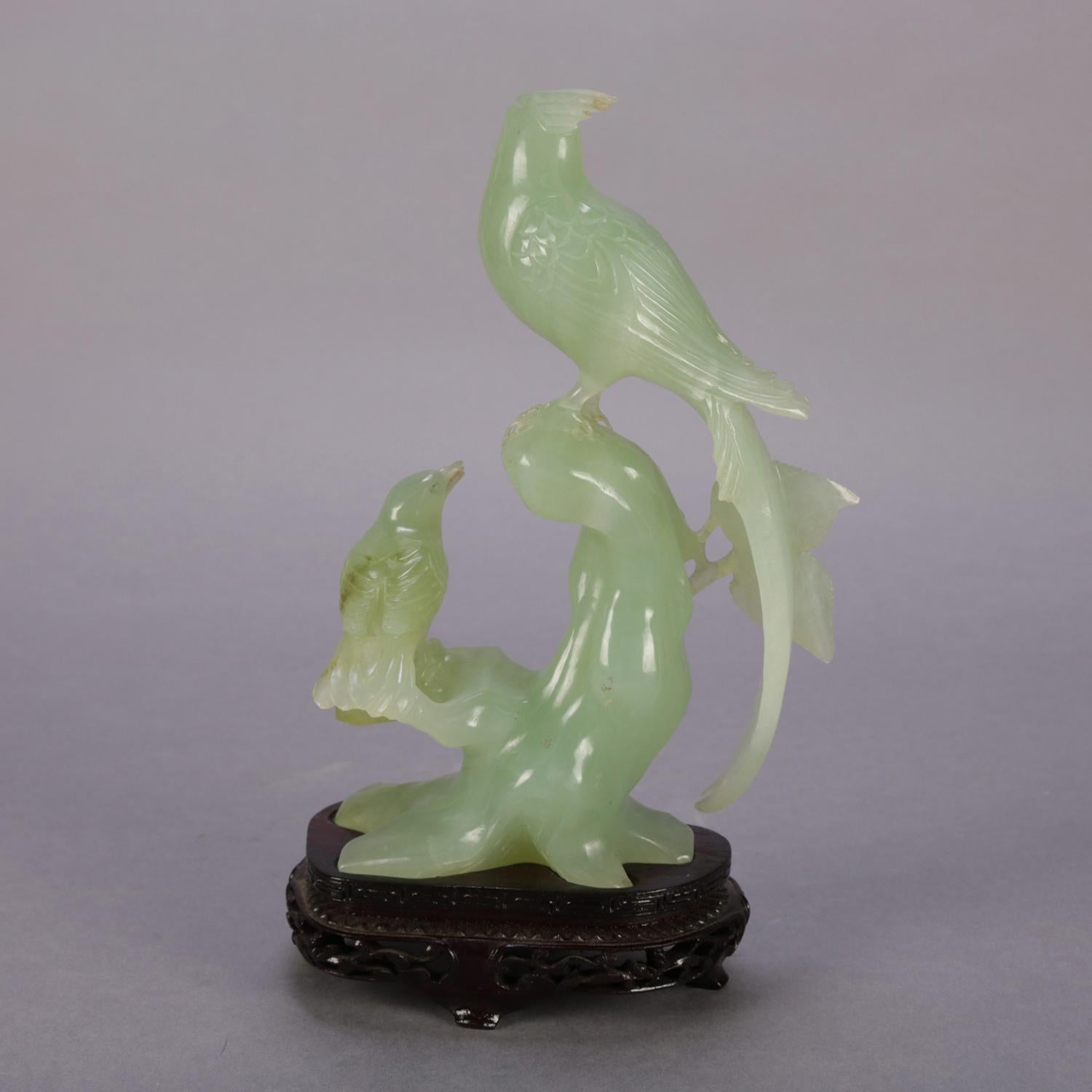 Chinese carved jade figural sculpture grouping of pheasant and sparrow (birds) on branch and seated on carved hardwood stand, 20th century

Measures: 9