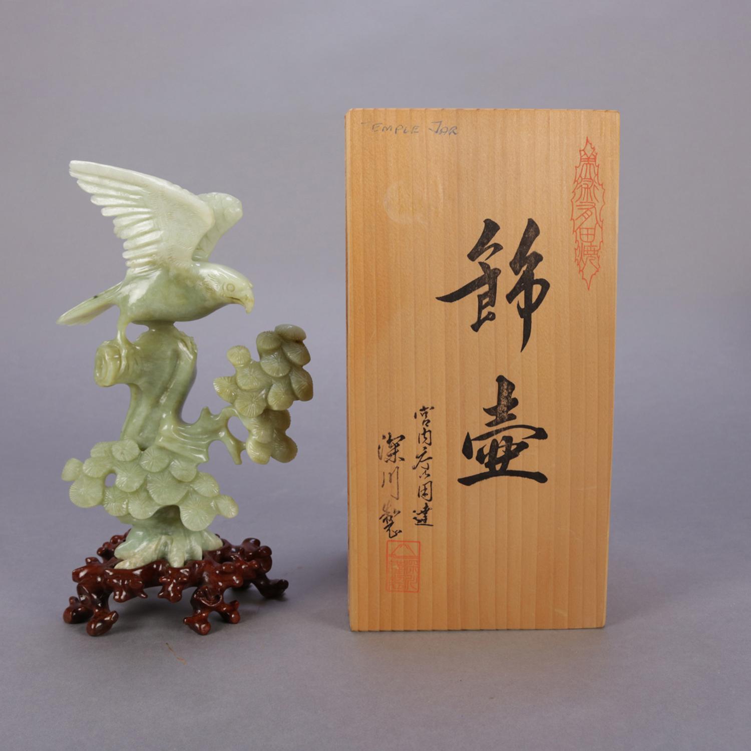 Chinese carved jade figural sculpture of spread eagle hawk (bird) on tree branch and seated on carved hardwood stand, original box, 20th century.

Measures: Box 9.5