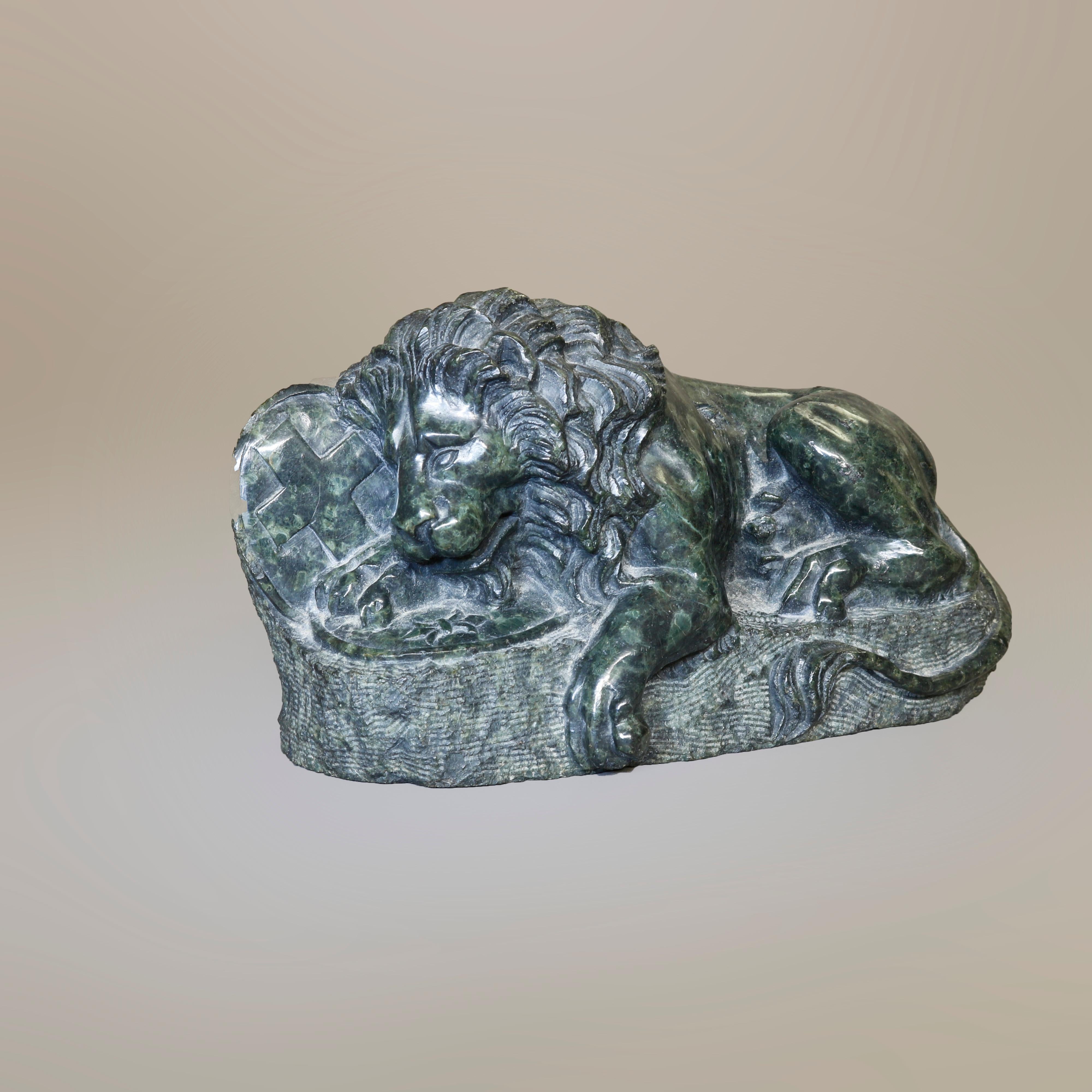 A Chinese hand carved victory sculpture depicts lion resting against shield, 20th century

Measures - 3.5''H x 6.25''W x 2.5''D.