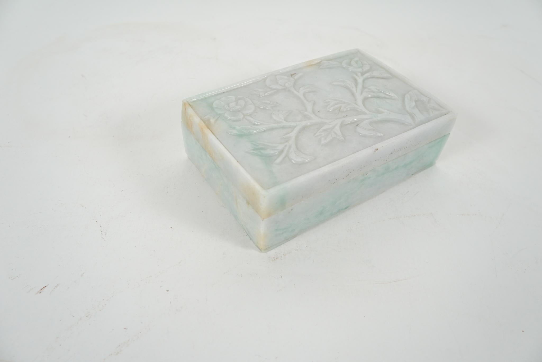 Made in the late Republic Period, circa 1945 to 1950, this box was purchased in China in 1990. The boxes carved jadeite ranges from a lovely soft translucent white to a rich green in veins that crisscross the stone with some natural brownish
