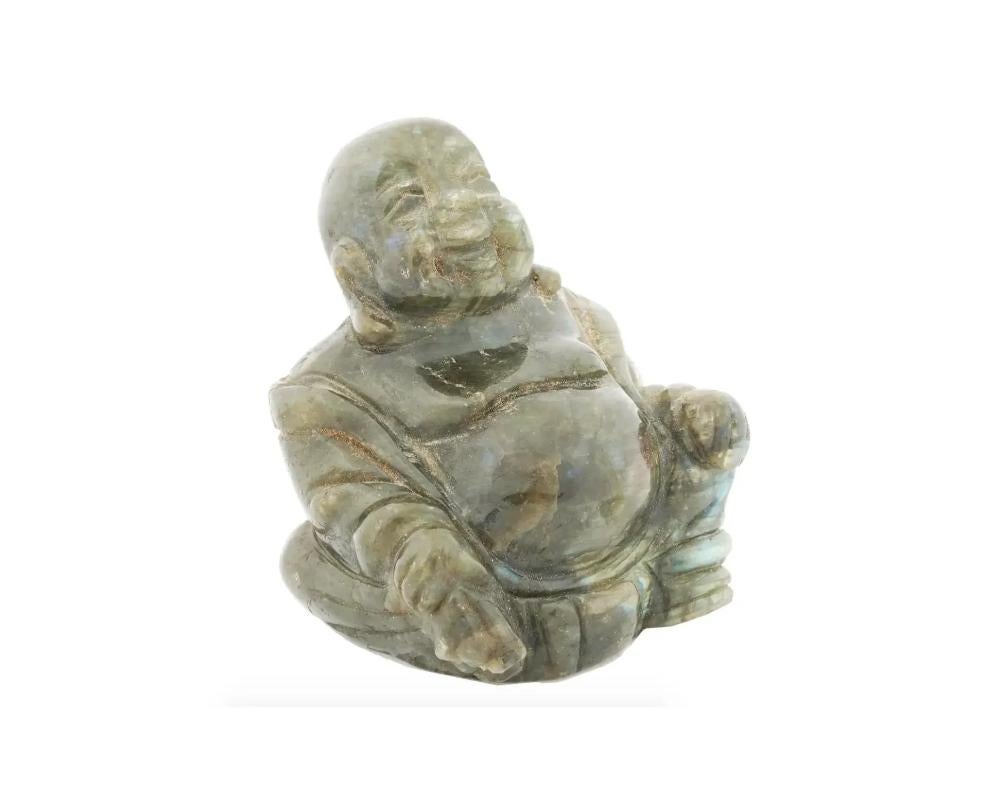 A Chinese hand carved Labradorite stone figurine. The figurine is made in the shape of laughing Buddha or Hotei. Circa: the first half of the 20th century. These figurines have been used as exquisite ceremonial artifacts, now they can be used as a