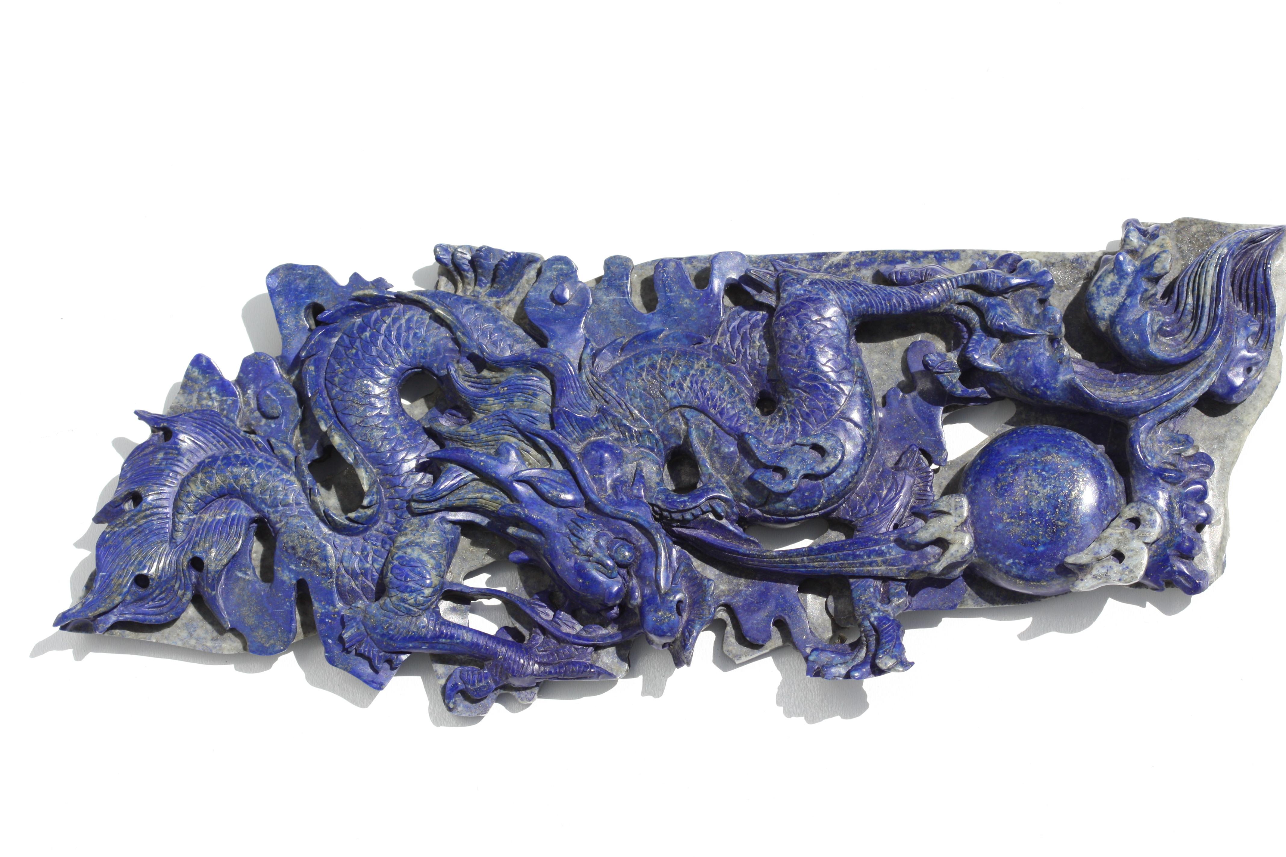 
Chinese Carved Lapis Lazuli Dragon
The vertically pierced and carved wreathing dragon in pursuit of the flaming pearl, on an elaborately carved wood stand.
Height 14.5 in., Overall Height of dragon, 17.5 in., Width 6 in., Depth, 1.5 in., Height