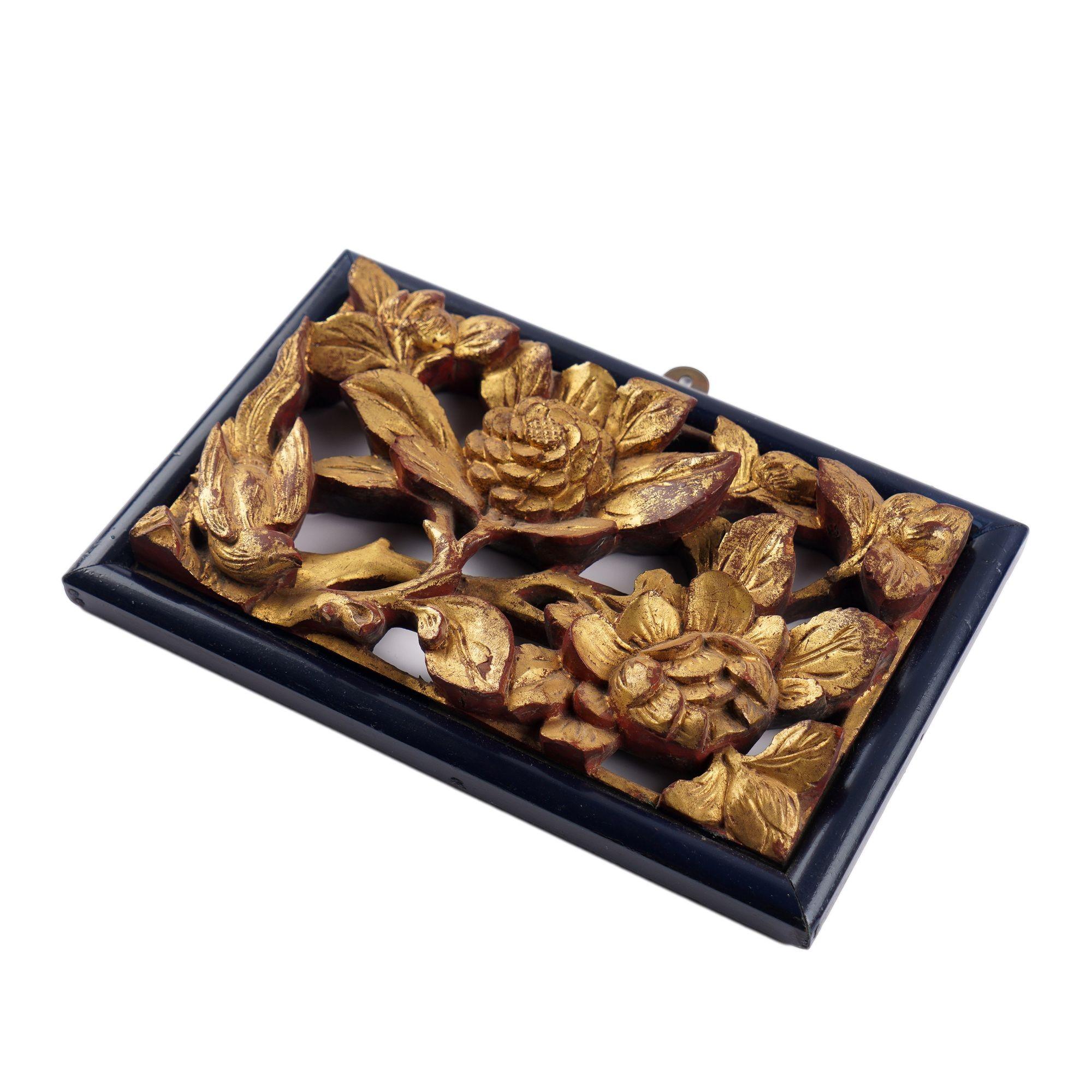 Carved & pierced gilt wood plaque of a bird among blooming peony within a dark blue/black pillow molding.
China, Qing dynasty, 19th century.