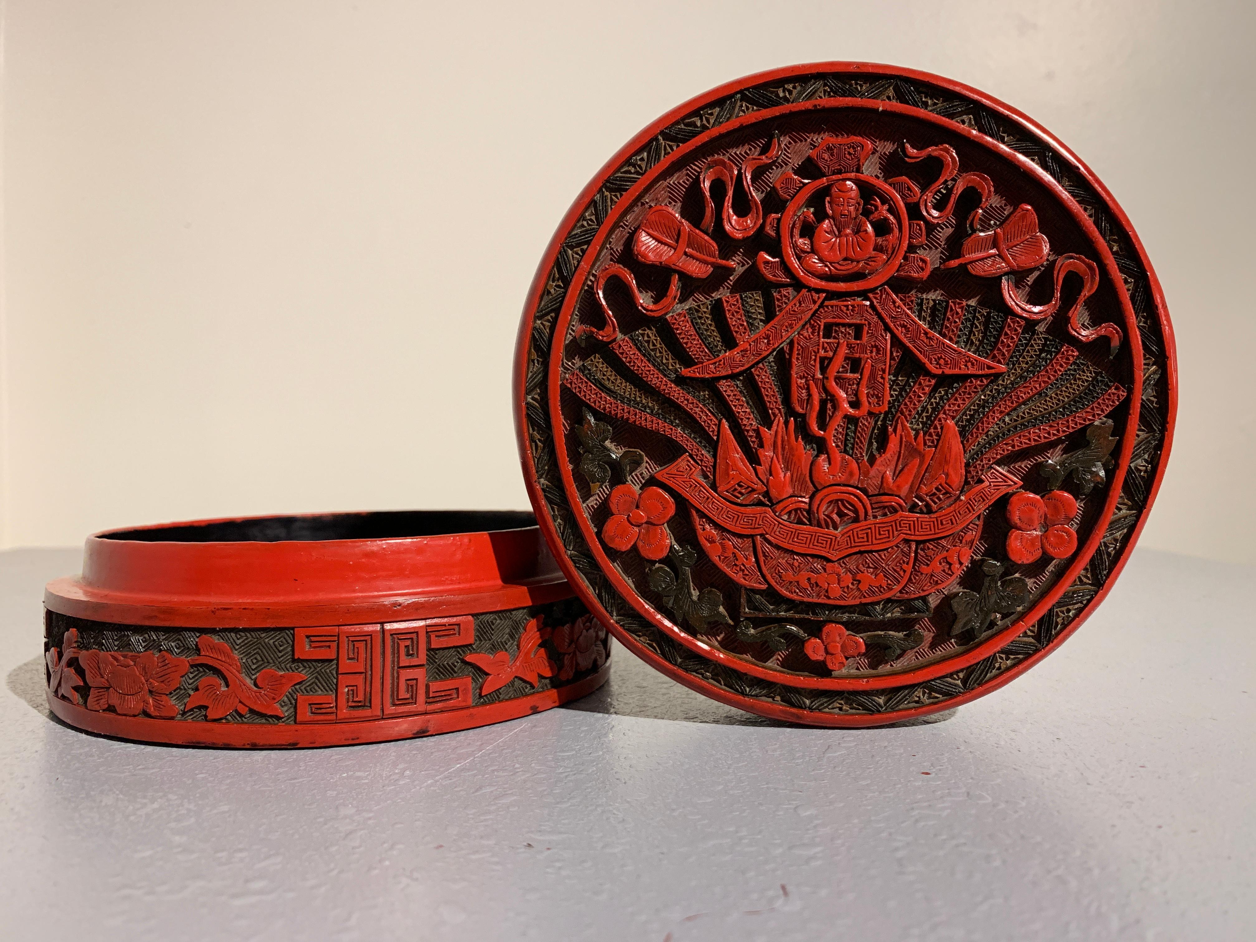 A rare and finely carved Chinese Qing dynasty round, three color cinnabar lacquer 