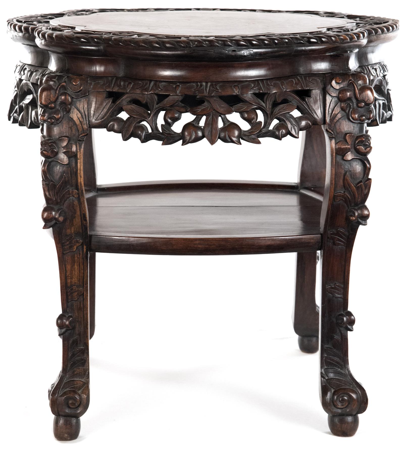 A Chinese captured-top table inset with a scalloped cartouche-shaped marble top bordered by a conforming carved edge with raised blossoming branch motif decoration, above an richly carved and pierced apron with ornate vine motifs. All raised on