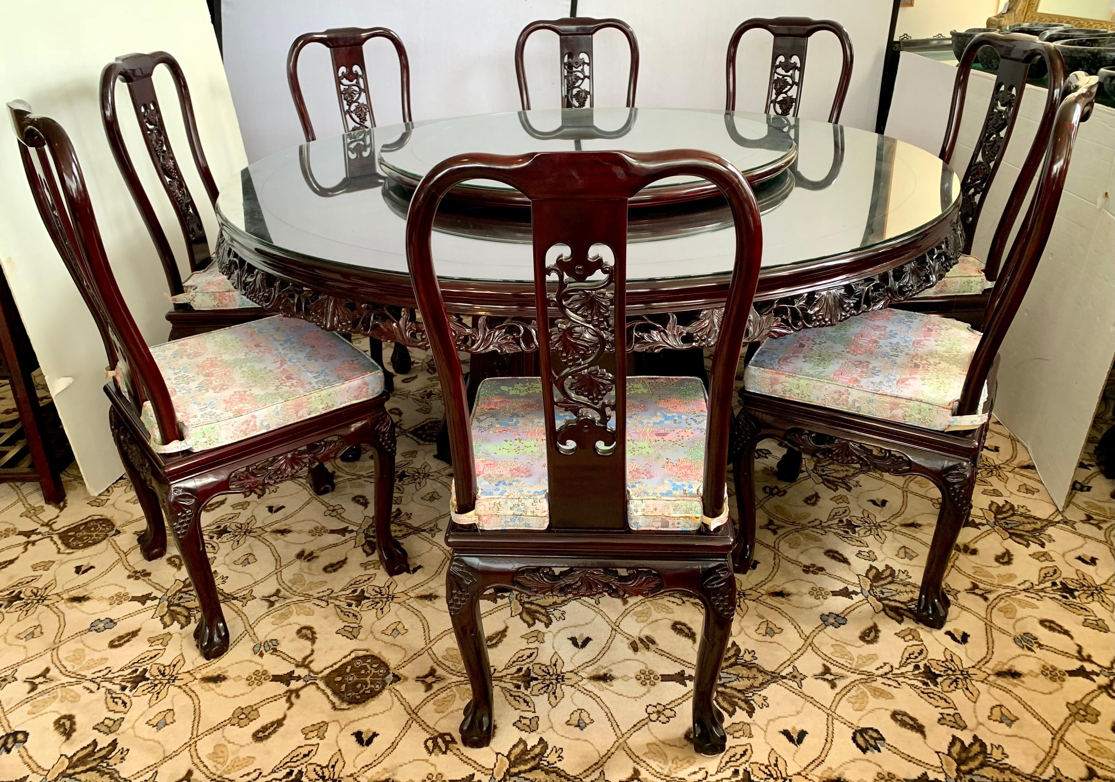Magnificent Chinese rosewood carved dining room set which features a hand carved grapes and vines all around the apron and pedestal of the table. It also has a 
