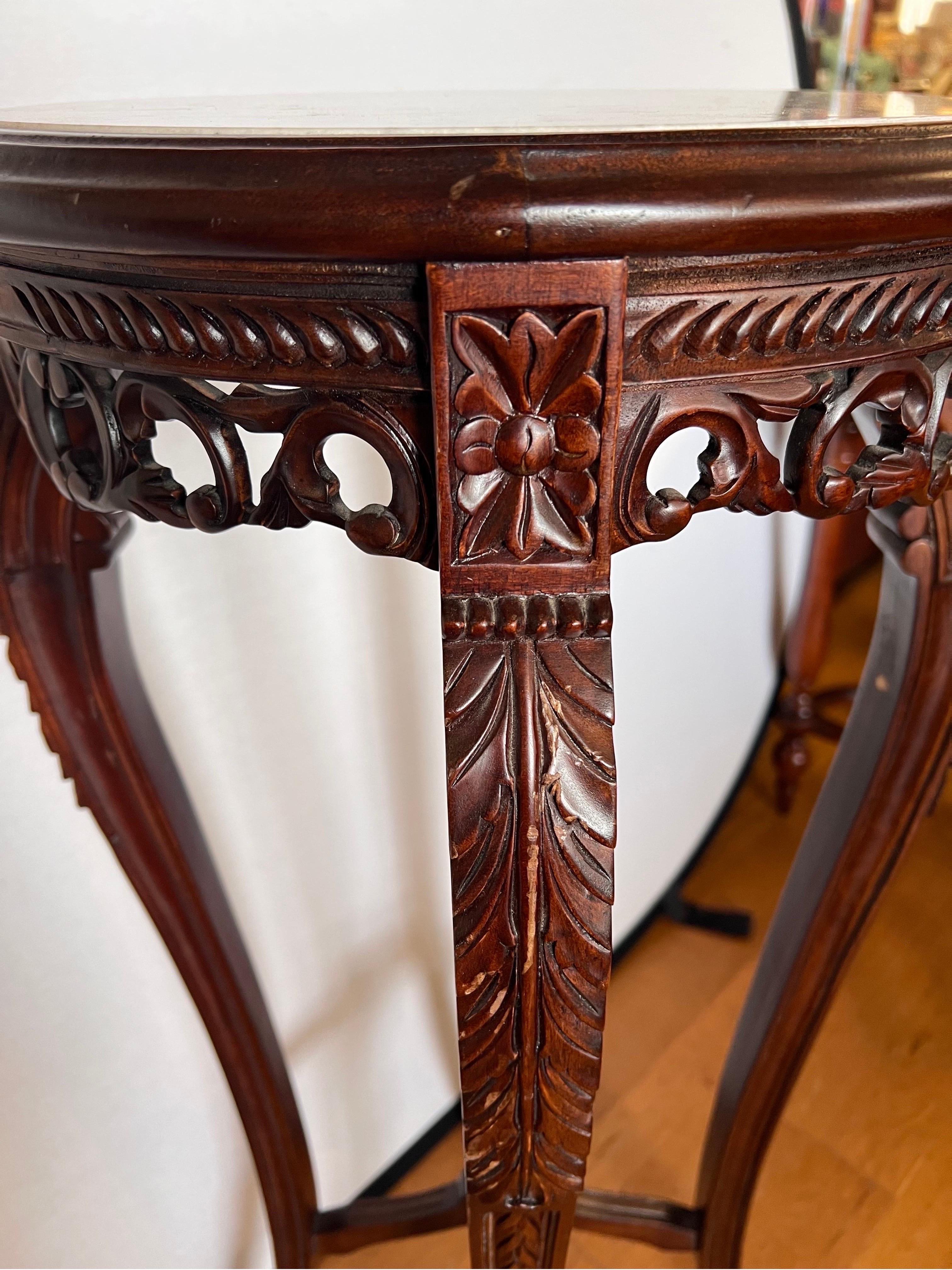 This exceptional piece showcases the artistry of Chinese craftsmanship and the timeless beauty of rosewood. Intricately carved details adorn the pedestal.