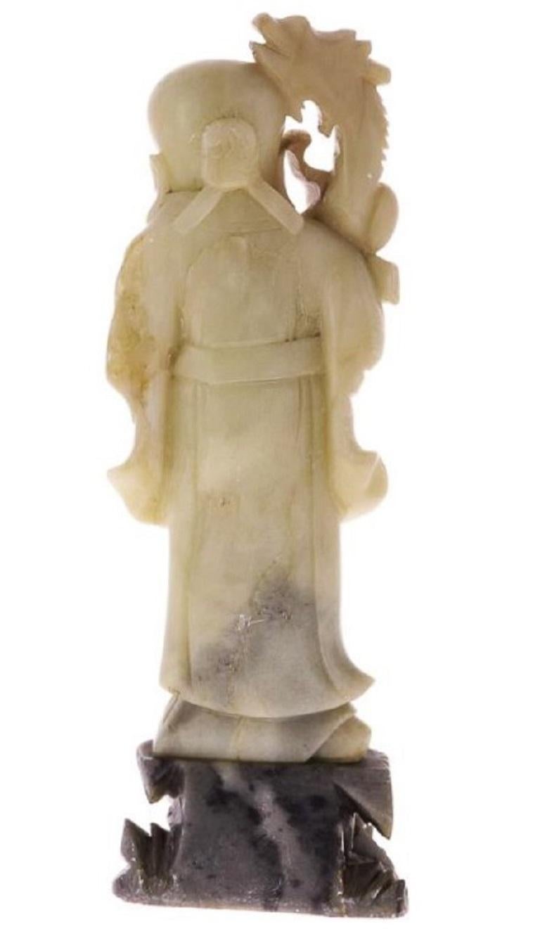 A finely carved soap stone sculpture of a wise ancient with a dragon on his shoulder standing on a braun soap stone base. In fine original condition.
Measures: Height 15