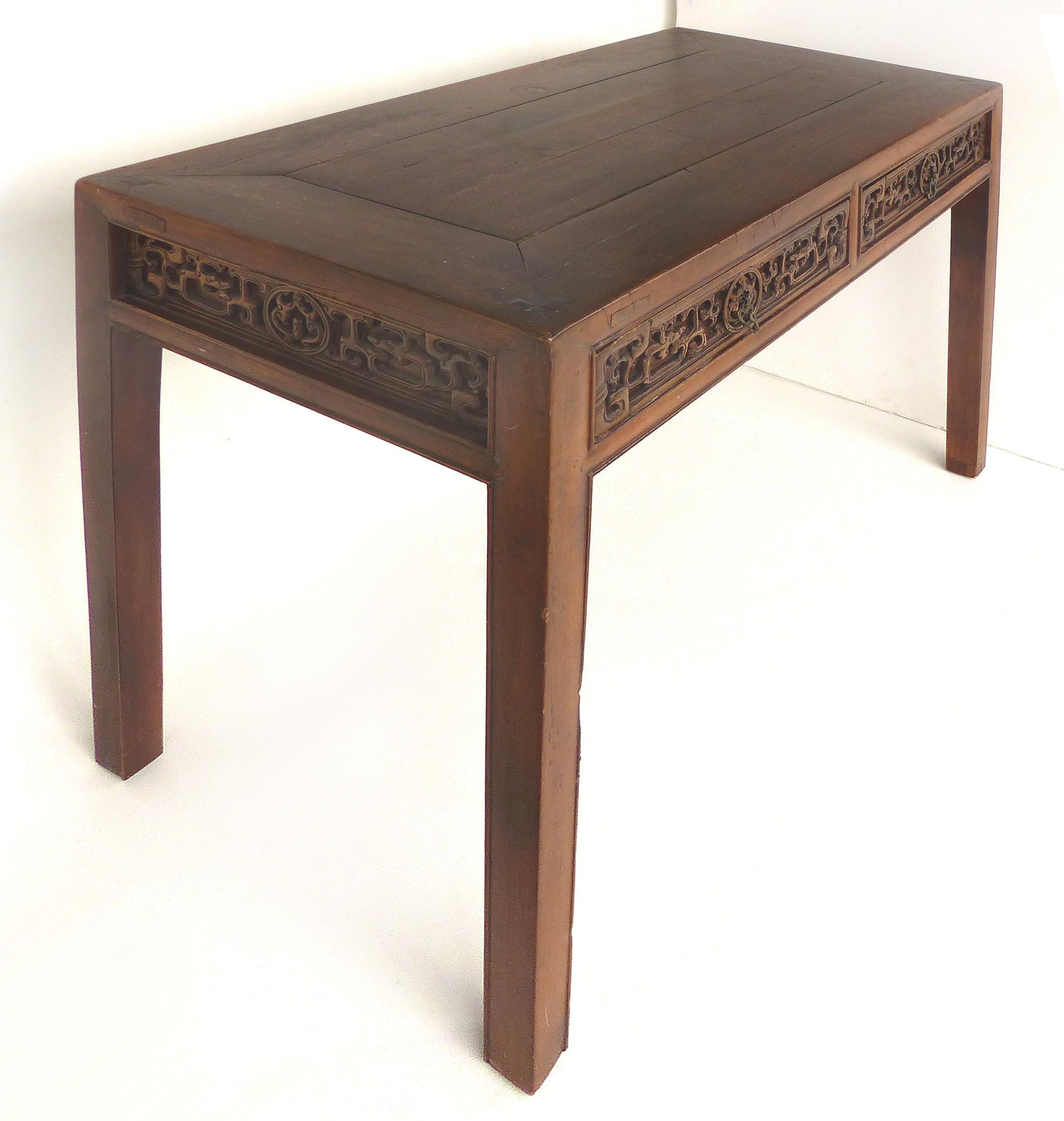 Chinese Carved Two-Drawer Console Table with Carved Apron

Offered for sale is a Chinese two-drawer carved console table with a nicely carved apron with panels on all sides including the back as pictured. The two drawers open to reveal dove-tailed