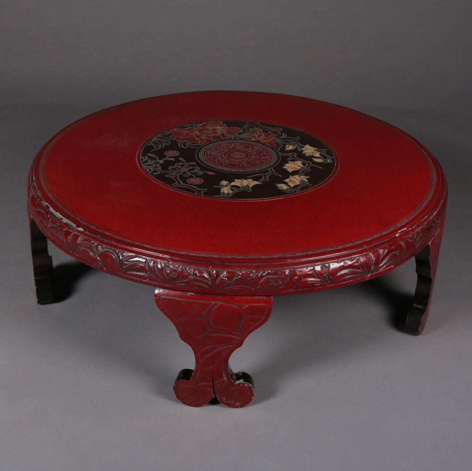 Chinese vermilion lacquered low coffee table features central floral medallion, carved Greek key bordering and foliate fore edge, raised on foliate incised scroll feet, circa 1920.

Measures: 13