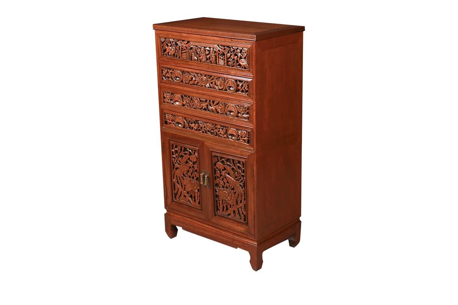Intricately carved serving vintage silver jewelry buffet cabinet chest of drawers from Southeast Asia, circa 1960s. Features beautiful Chinese wood relief flowers and birds pattern throughout. The hinged top lifts to reveal a red velvet lined