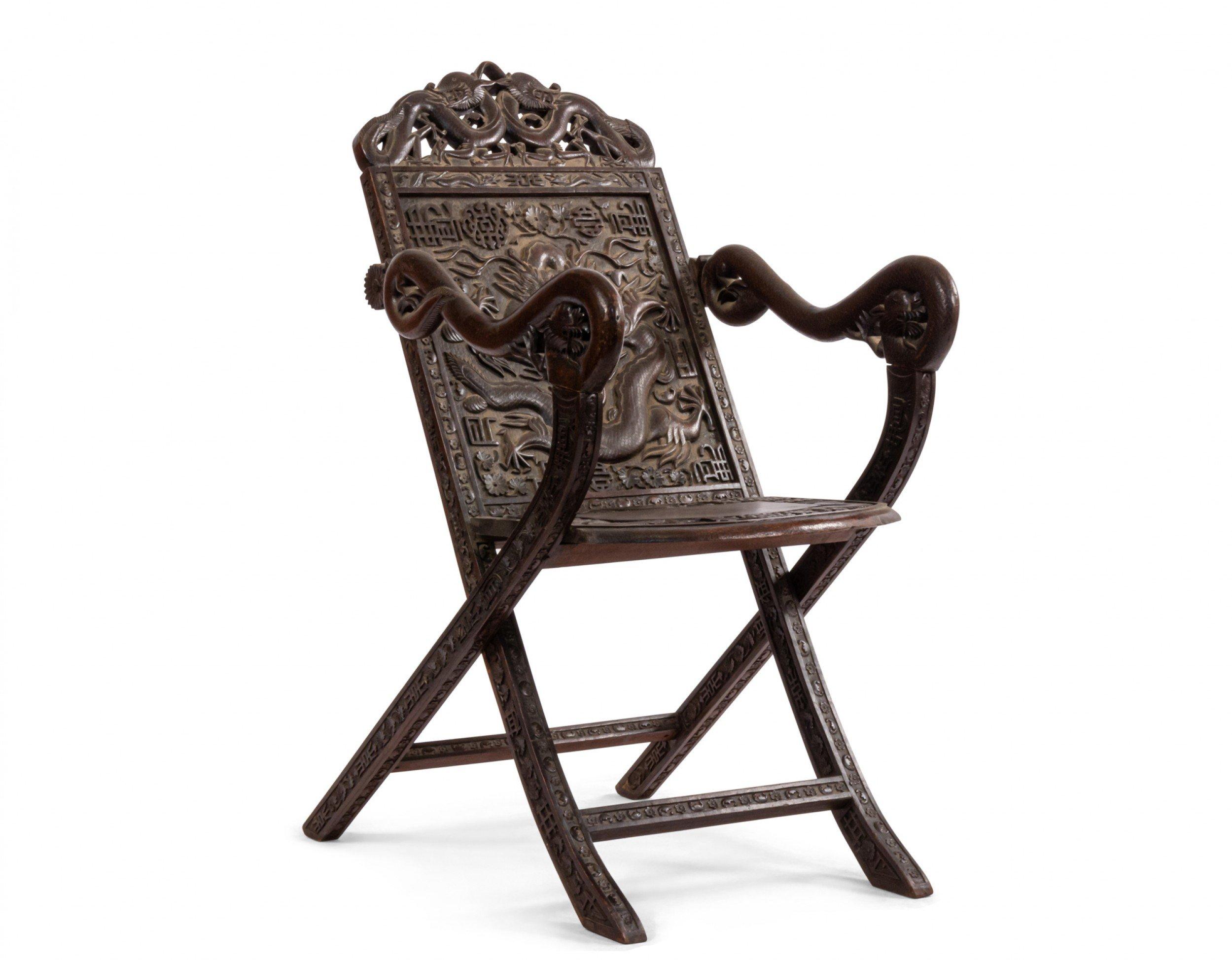 Asian Chinese style carved walnut folding campaign style arm chair with dragon carved back and arms (19th Cent.)