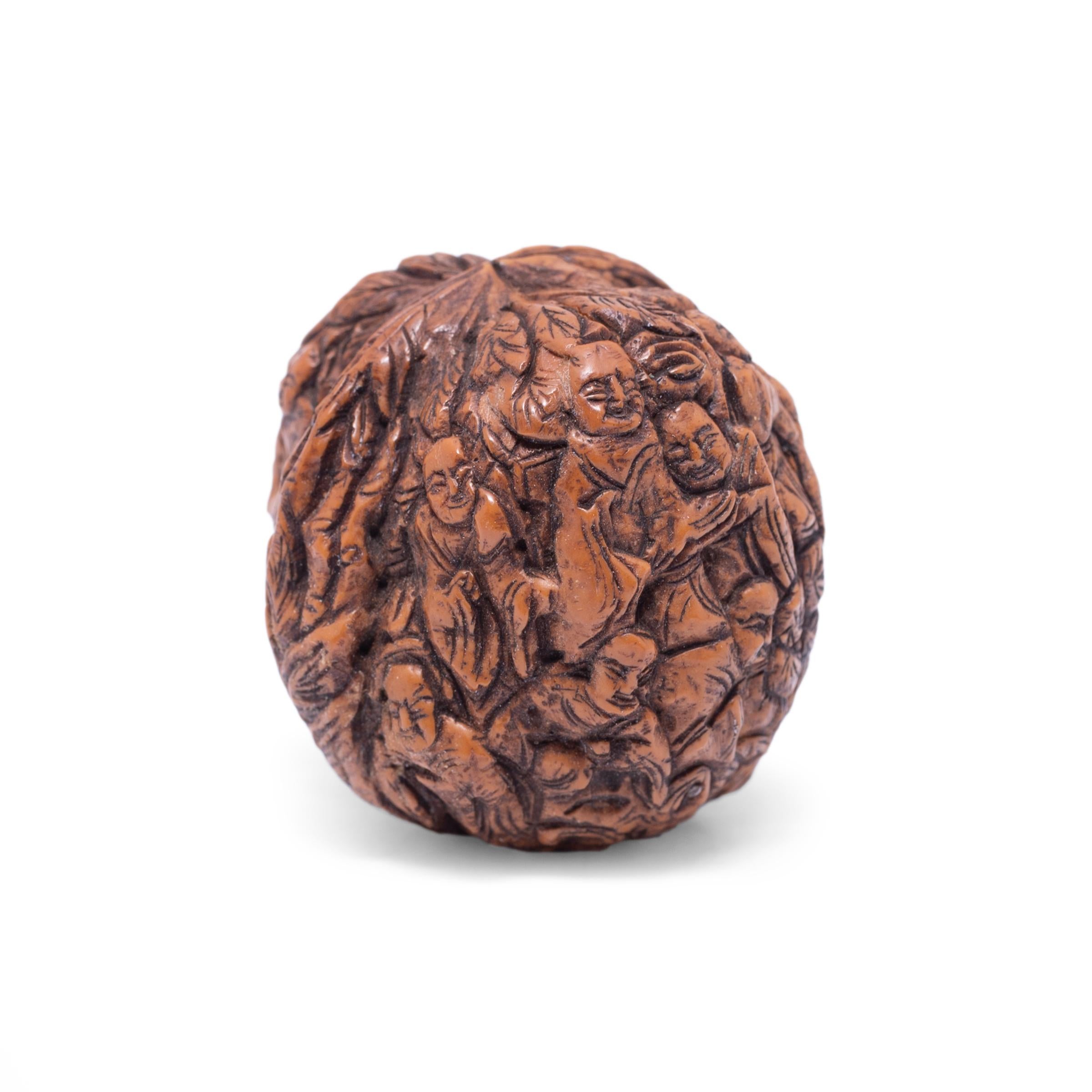 Chinese nut carving is a traditional craft that dates back as far as the Song dynasty (960 to 1279). The practice allowed carvers to showcase their skill by creating intricate works on minute surfaces such as walnuts or peach pits. This polished