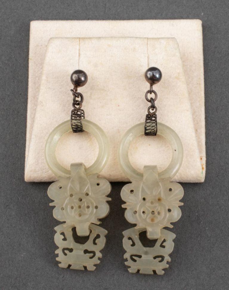 Chinese pair of earrings with carved round jade hoops suspended by two articulated pierced white jade drop pendants and silver post backs, the jade carvings likely Qing Dynasty (1636-1912). Dimensions:  2.5