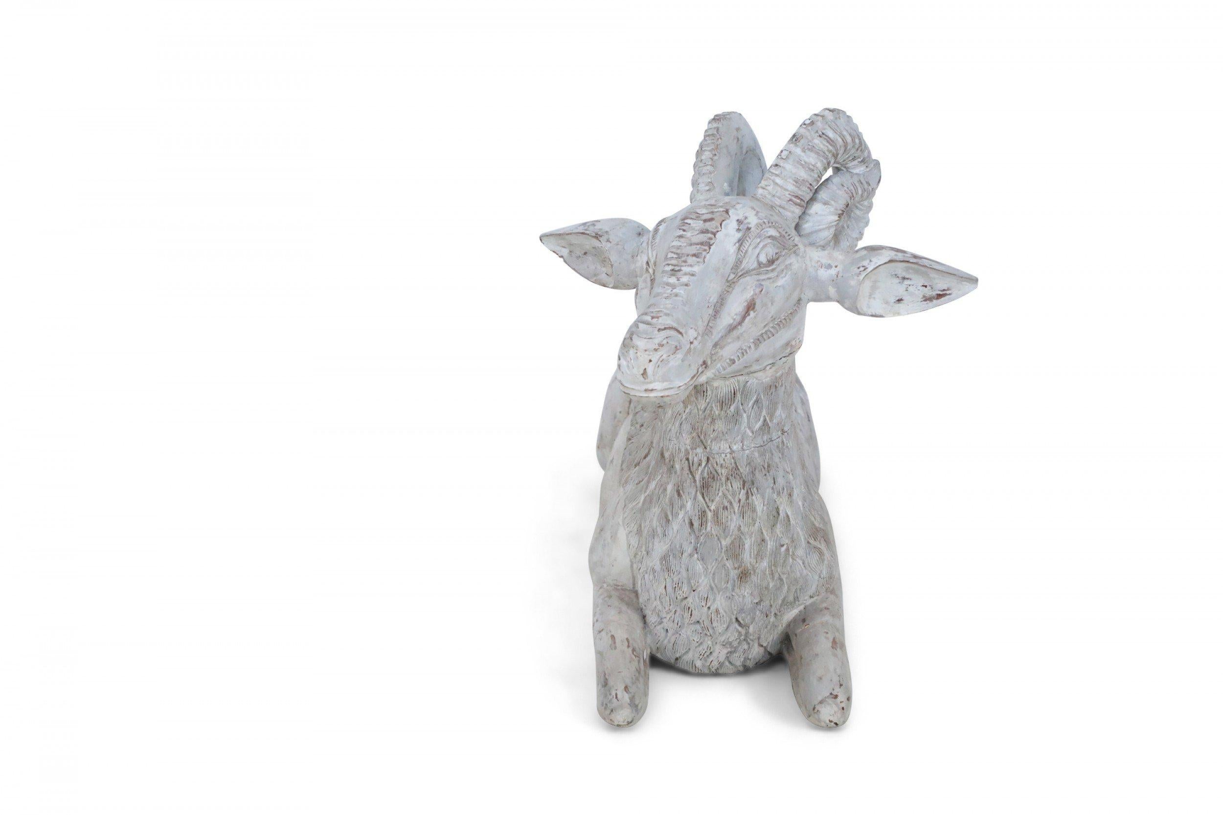 Chinese carved wooden ram lying down and painted with a whitewash finish.