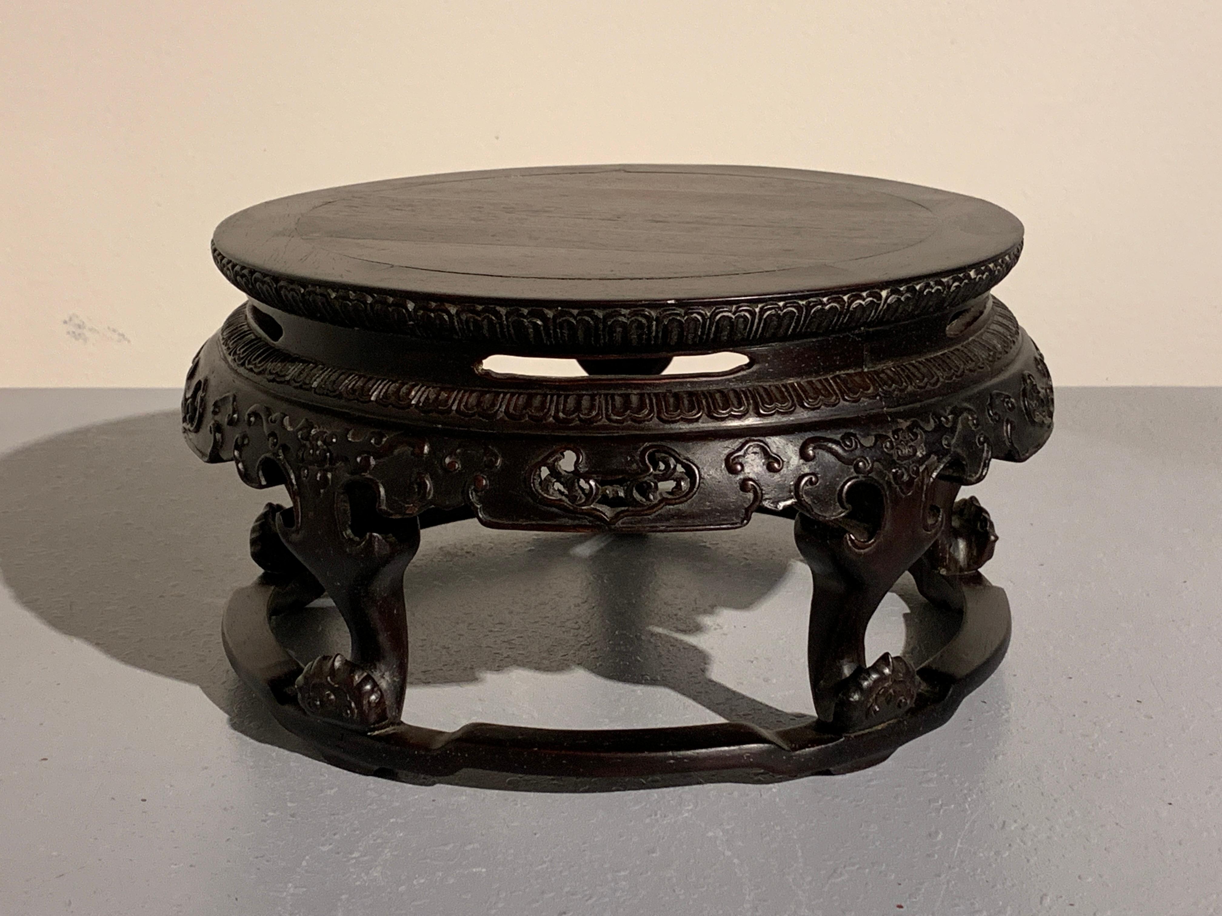 A finely carved zitan wood display stand in the form of a round table, China, Republic Period, mid 20th century. 

The circular display stand carved from rare and precious zitan wood. Fashioned as a classical Chinese round table, the stand is