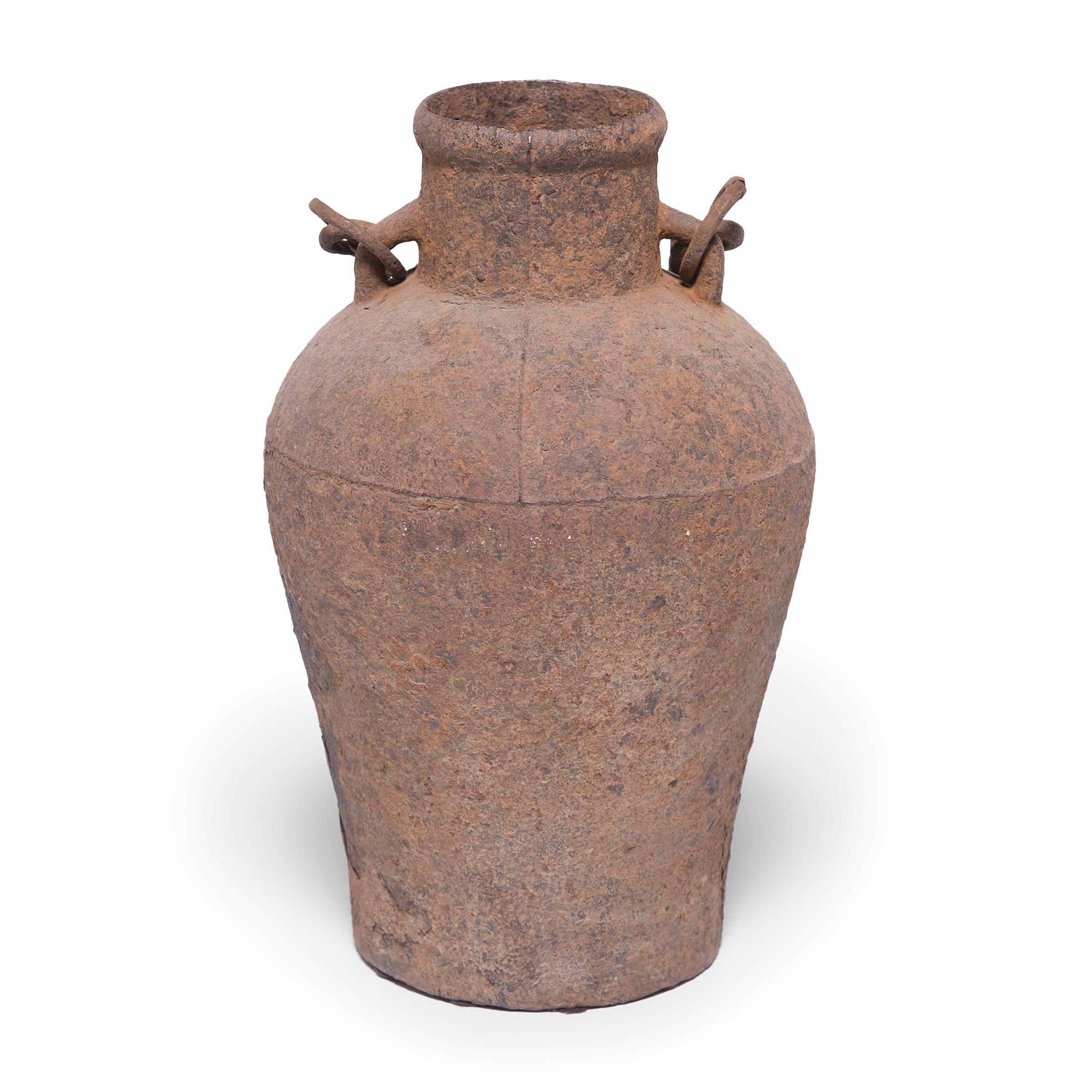 This cast-iron vessel has an elegant form reminiscent of the beautiful ironwork, bronzes, and ceramics perfected by Chinese artisans thousands of years ago. A century ago this jar would have been purely utilitarian, but over time, as the iron has