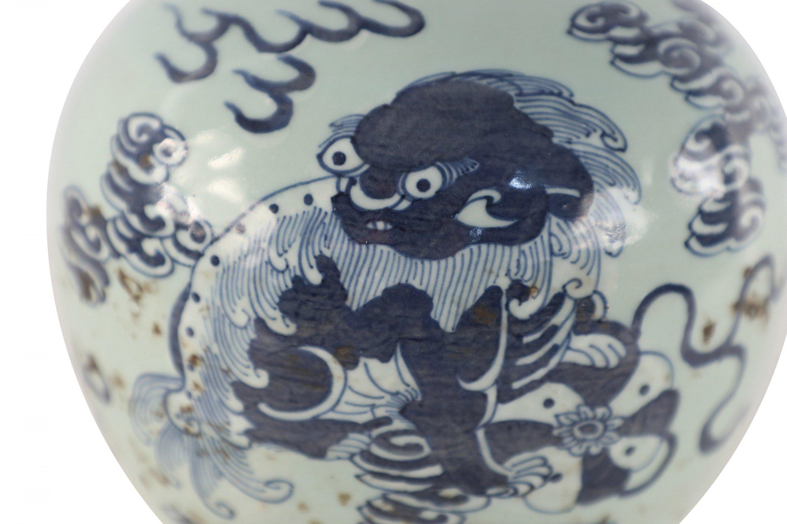 Chinese celadon porcelain vase painted with a blue dragon amid the clouds and made with a small mouth opening.
 