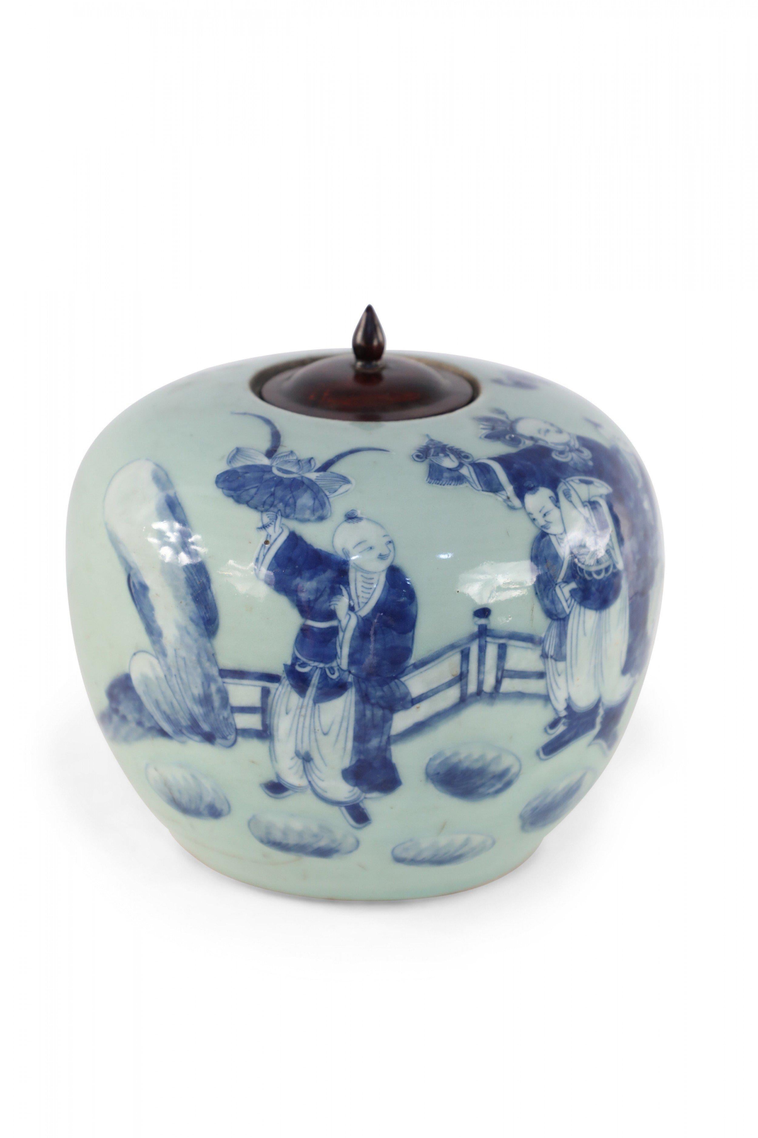 Antique Chinese (Early 20th Century) celadon ginger jar with a dark blue figurative scene and a turned wooden lid with a pointed finial.
 