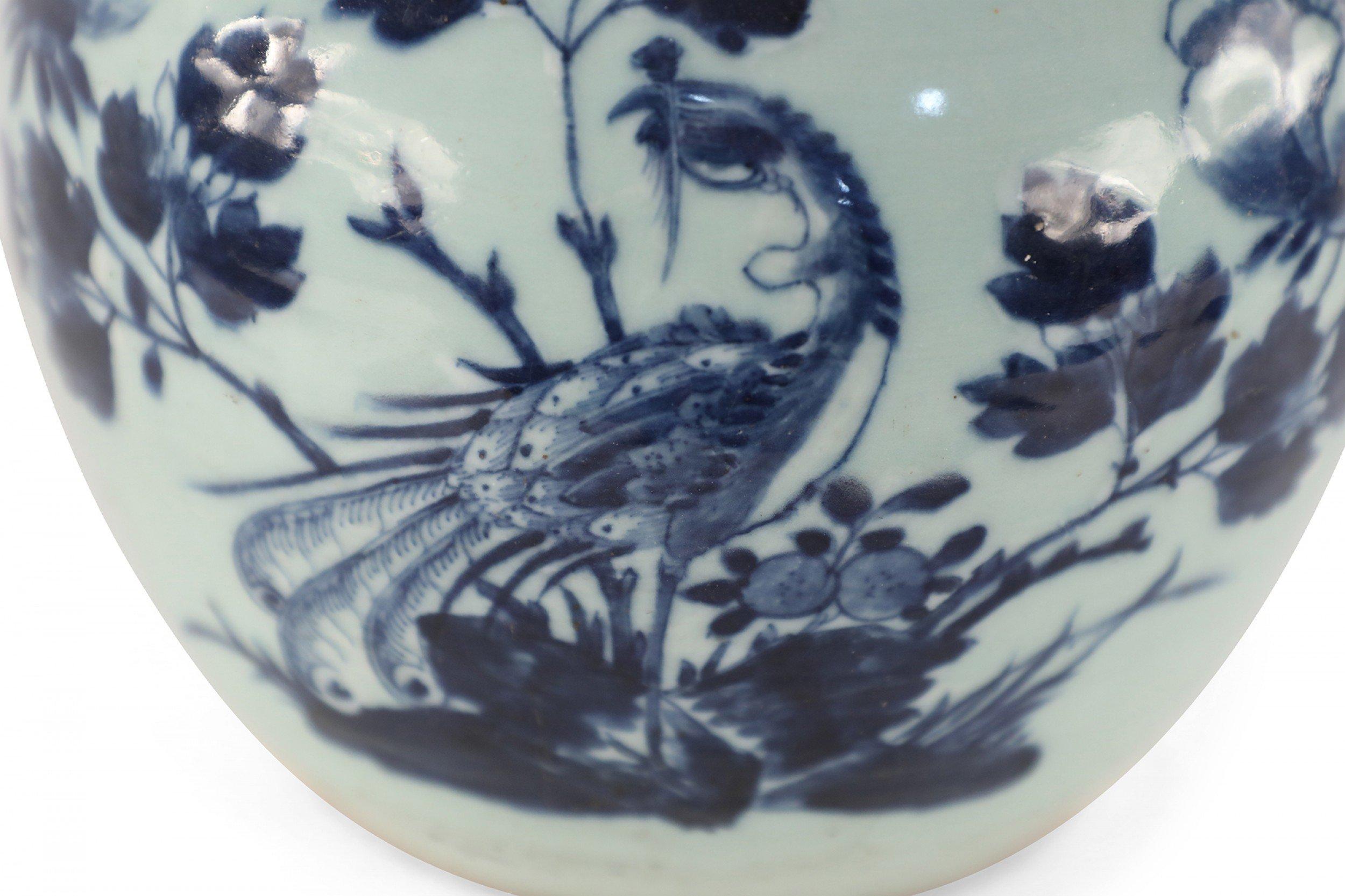 Antique Chinese (Early 20th Century) celadon, round porcelain vase with a small mouth opening, painted with a blue peacock and floral blossoms.
 
