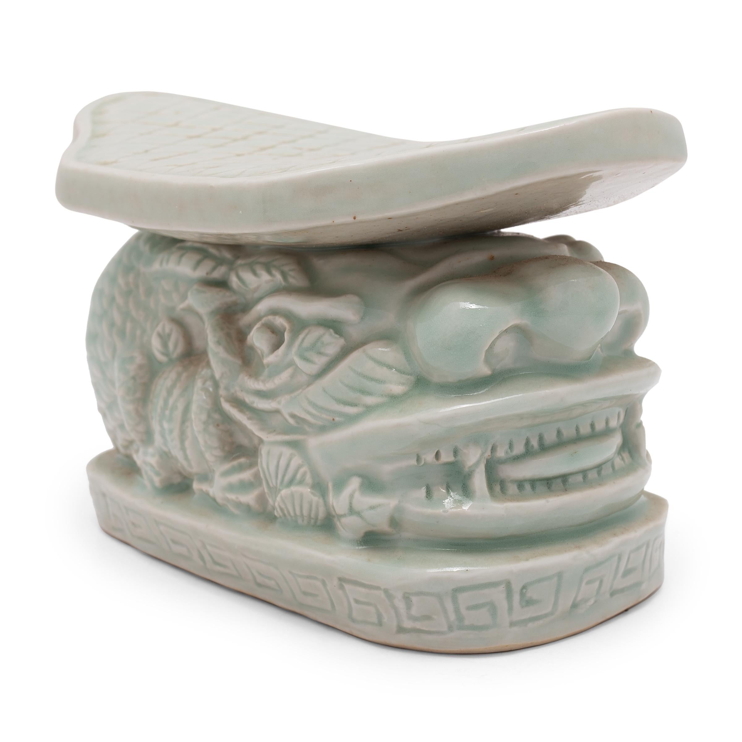 To keep their elaborate hairstyles intact while sleeping, well-to-do Qing-dynasty women used elevated headrests such as this in lieu of a pillow. This porcelain headrest dates to the early 20th century and was likely used for decorative, rather than