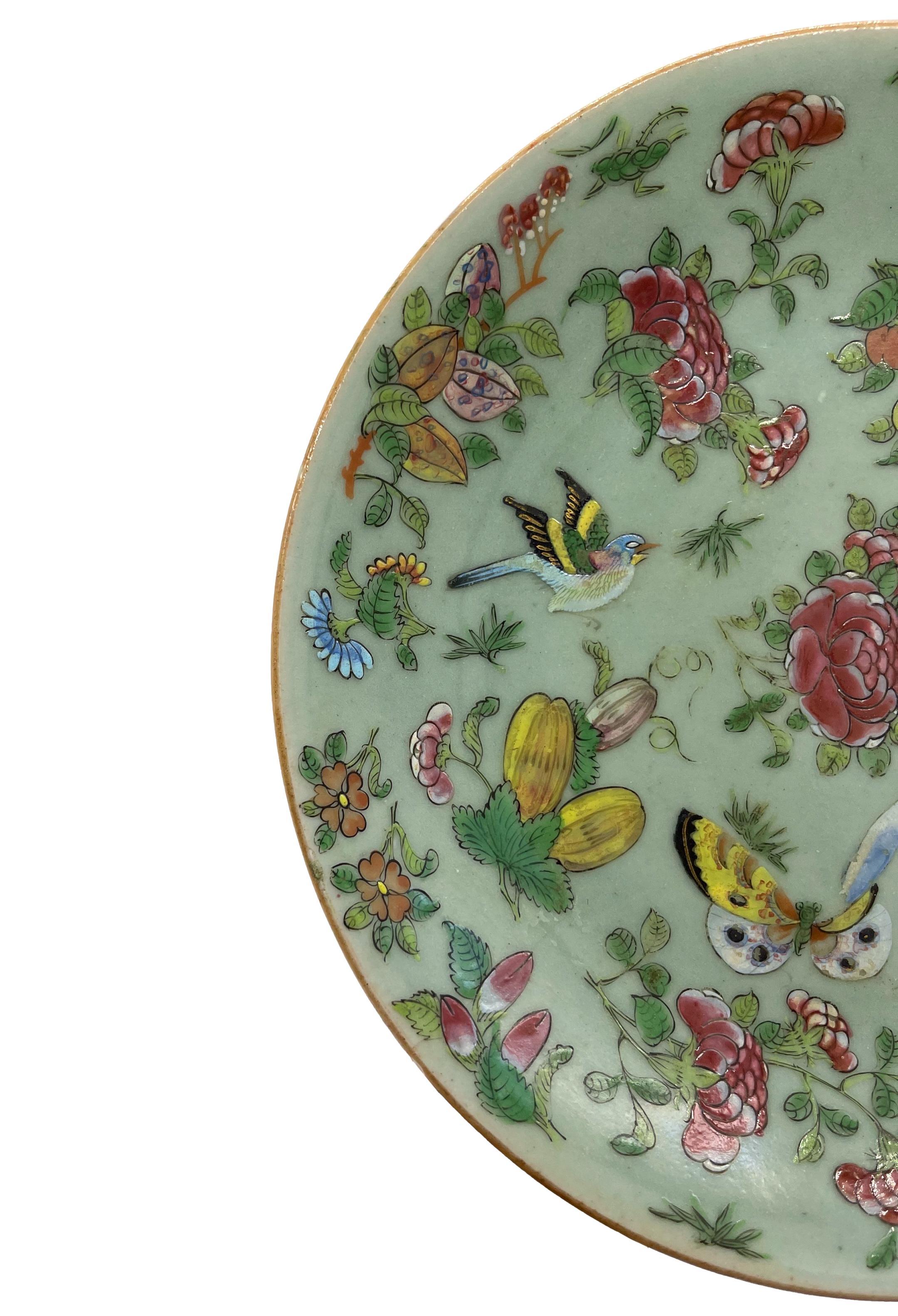 Chinese Export Porcelain Celadon Famille Rose 10-inch plate, Cantonese, Qing Dynasty, ca. 1850, profusely decorated in polychrome enamels depicting pheasants, butterflies, fruit, and florals on a blue-green celadon ground, the reverse with