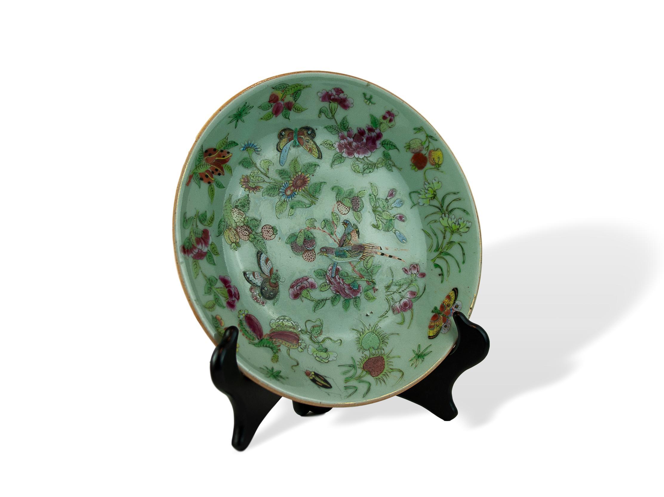 Chinese Export Porcelain Celadon Famille Rose 10-inch plate, Cantonese, Qing Dynasty, ca. 1850, profusely decorated in polychrome enamels depicting pheasants, butterflies, fruit, florals, with a single gilded cricket, on a blue-green celadon ground,