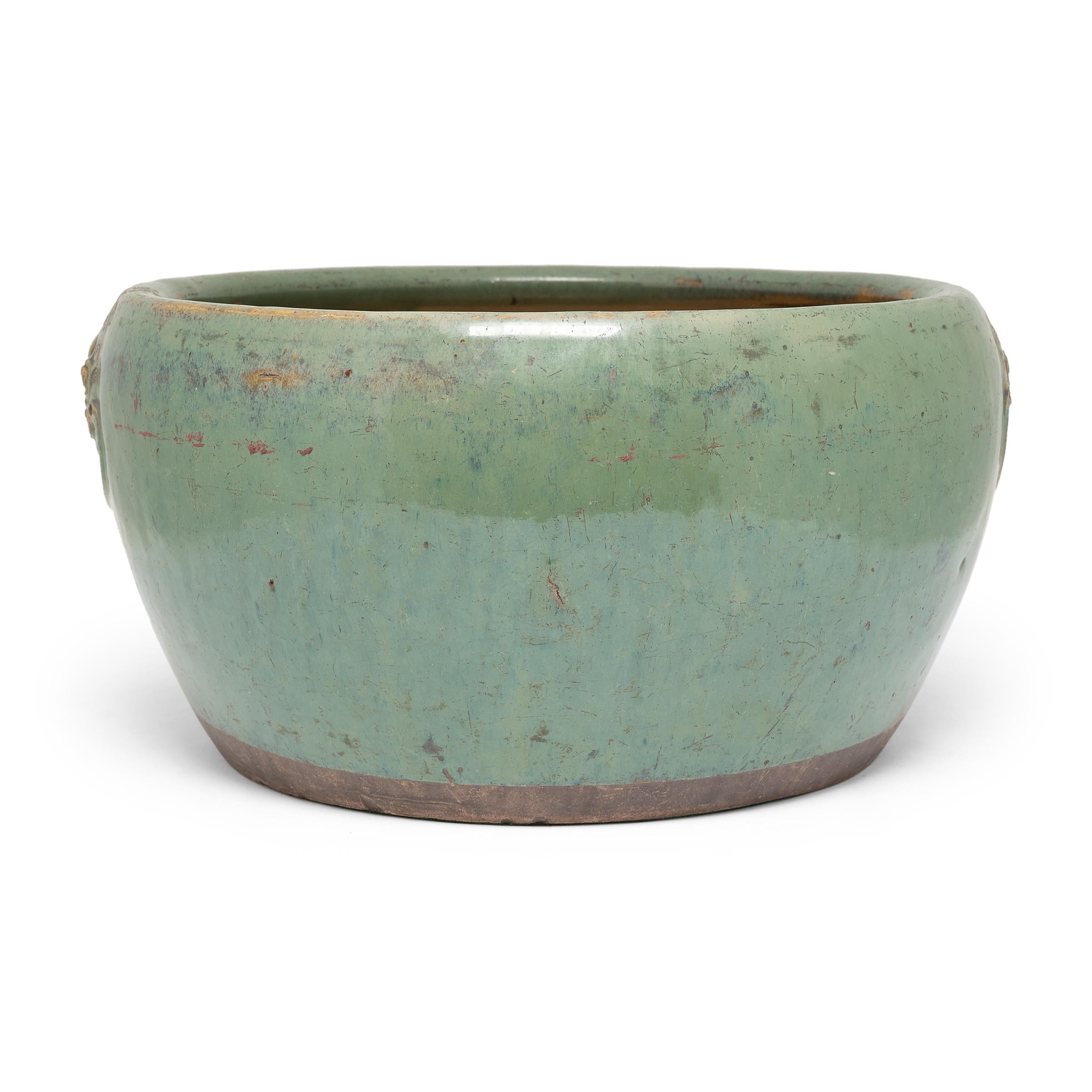 This low ceramic planter dates to the mid-19th century and was likely originally used as an indoor fishbowl. The basin has a round 