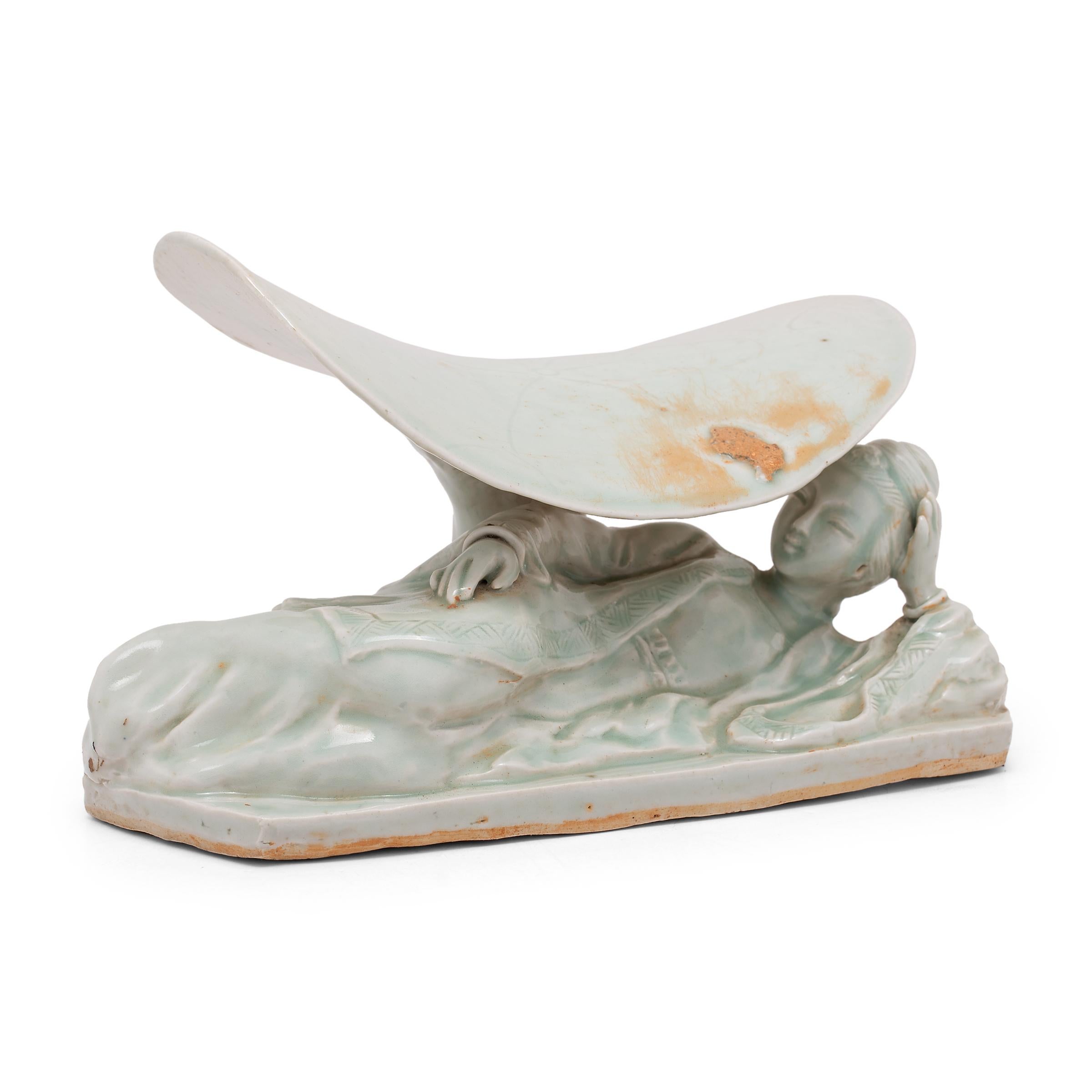 To keep their elaborate hairstyles intact while sleeping, well-to-do Qing-dynasty women used elevated headrests such as this in lieu of a pillow. Dated to the 19th century, this porcelain headrest is sculpted in the form of Guanyin. Known as the