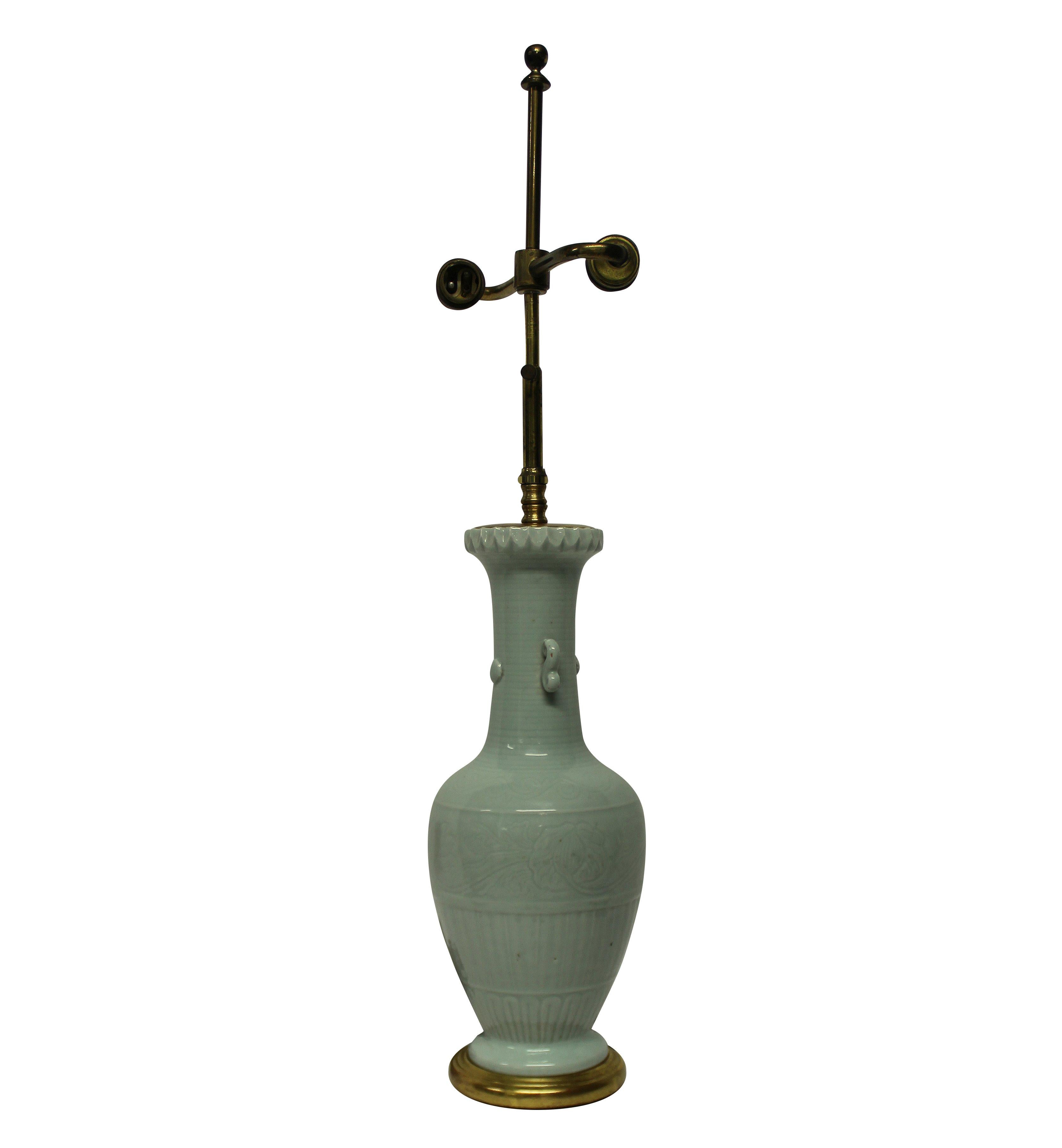 A Chinese porcelain celadon vase lamp, with water gilded turned base and brass fittings.