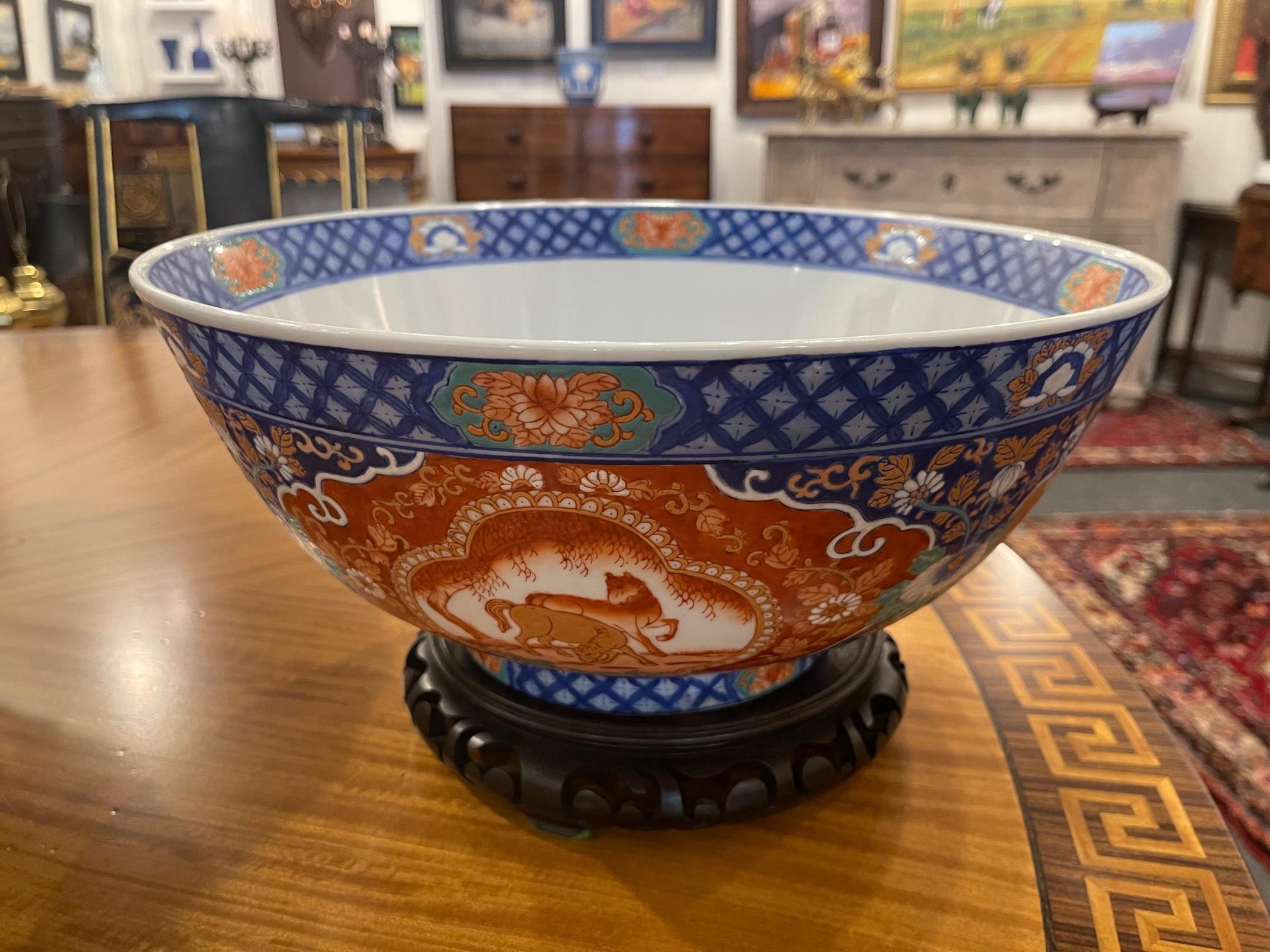 Chinese center or punch bowl on wood stand made by Maitland Smith, 20th century. Height on wood stand is 7.75