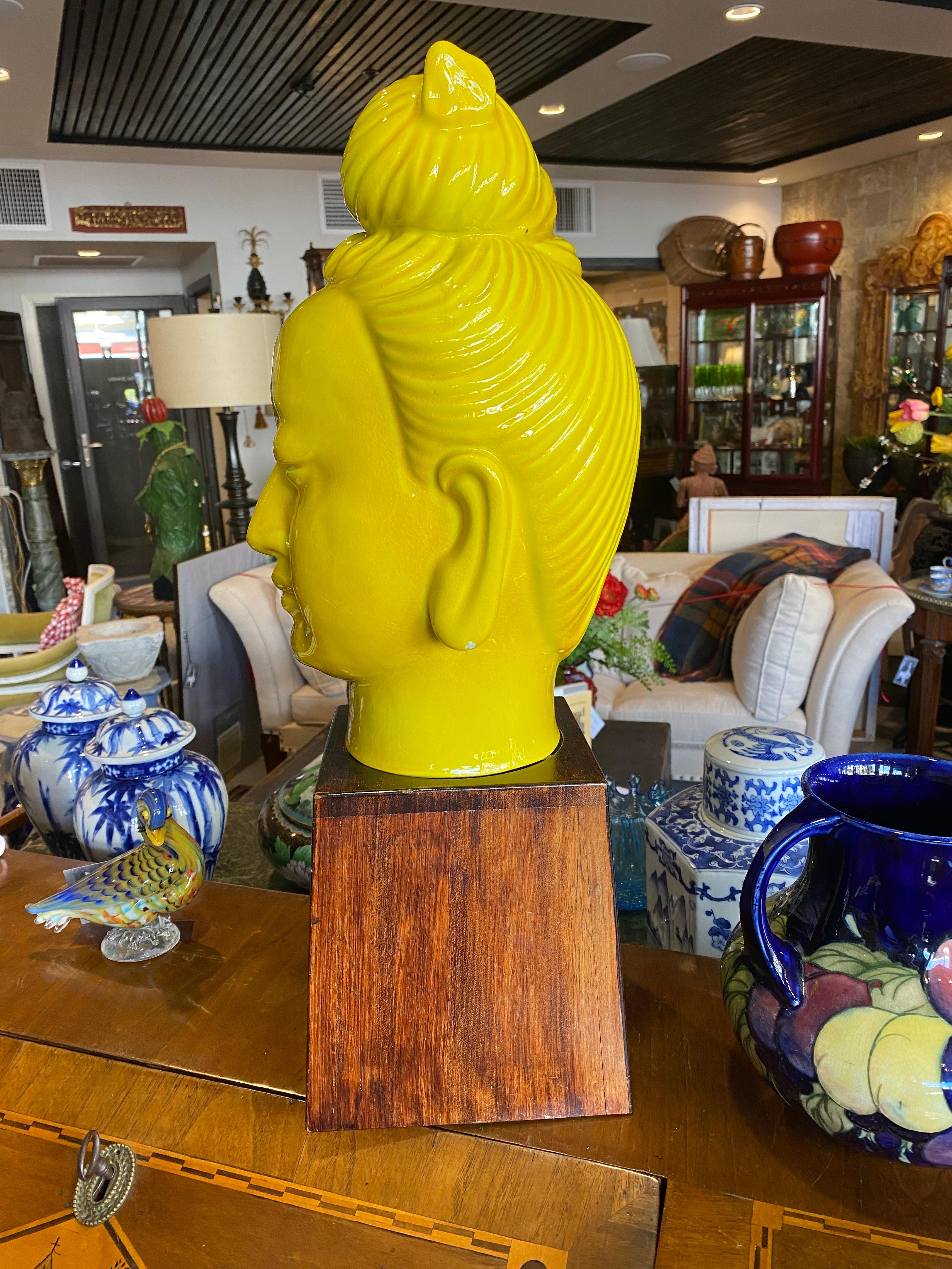 This piece was made in 1950-1960 you can tell by the yellow enamel paint and custom made wooden stand for this head. She has a different look then most a smile! For good luck.
