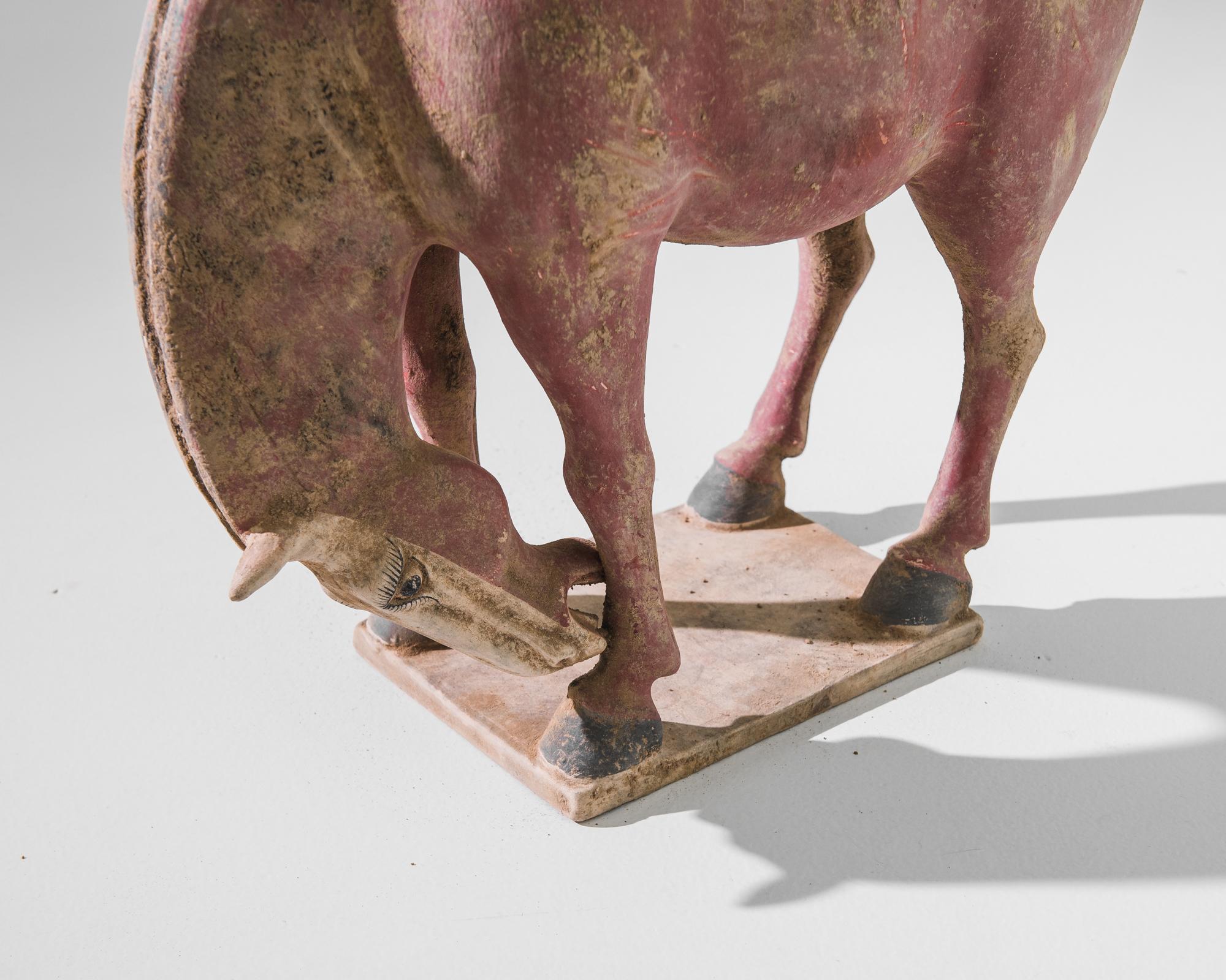 A warm, natural color palette — terra-cotta red and sun-baked sand — and a textural finish give this jubilant horse a wholesome appeal. The silhouette is simple and harmonious; the graceful arch of the neck is counterbalanced by the spirited